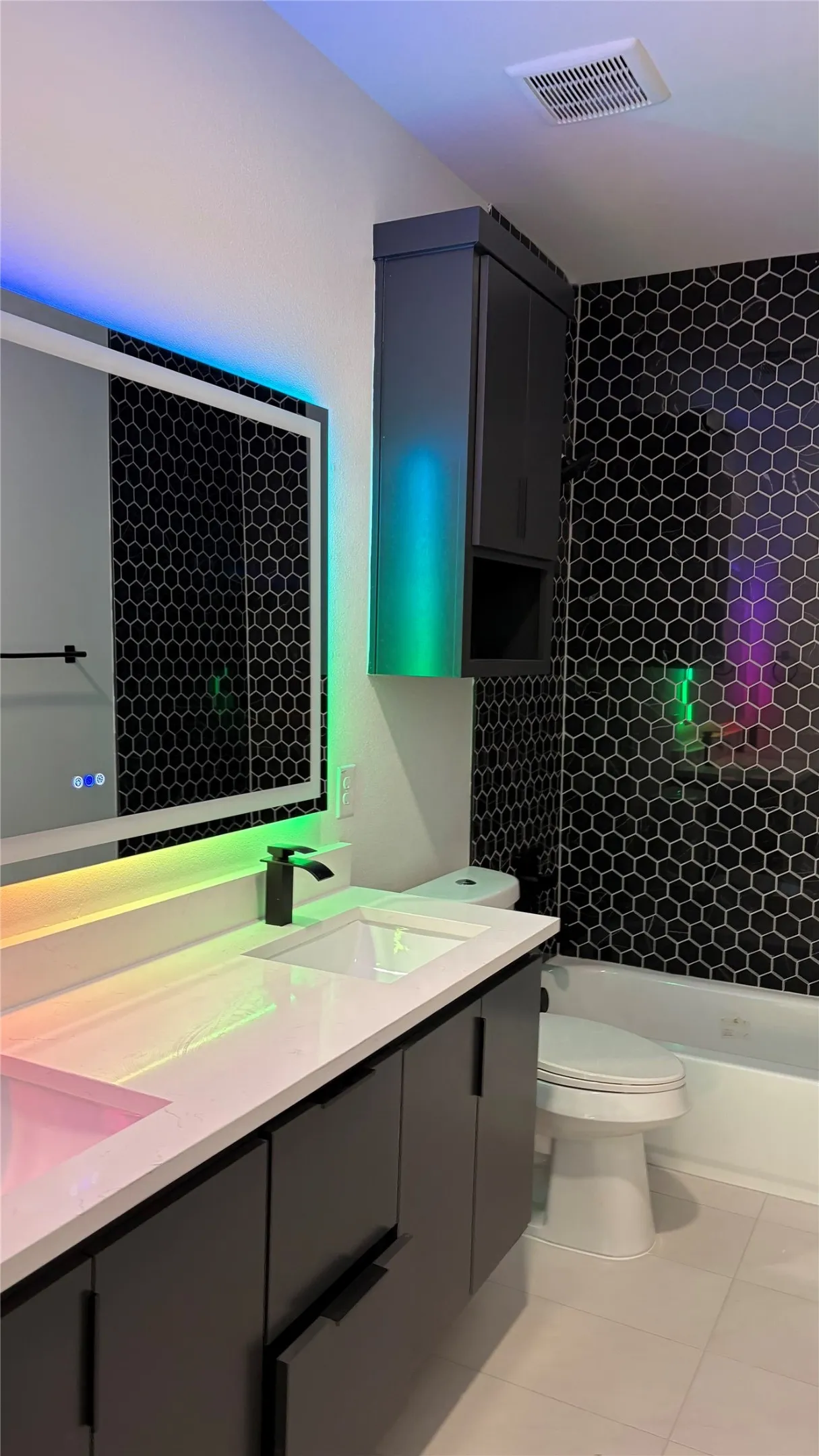 Modern vanity with a white countertop and rectangular undermount sink, complemented by a matte black faucet