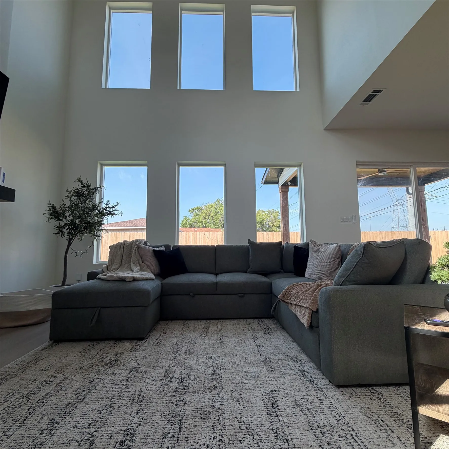 Double-height ceiling featuring tiered windows and wood-finish flooring, 20 ft fireplace