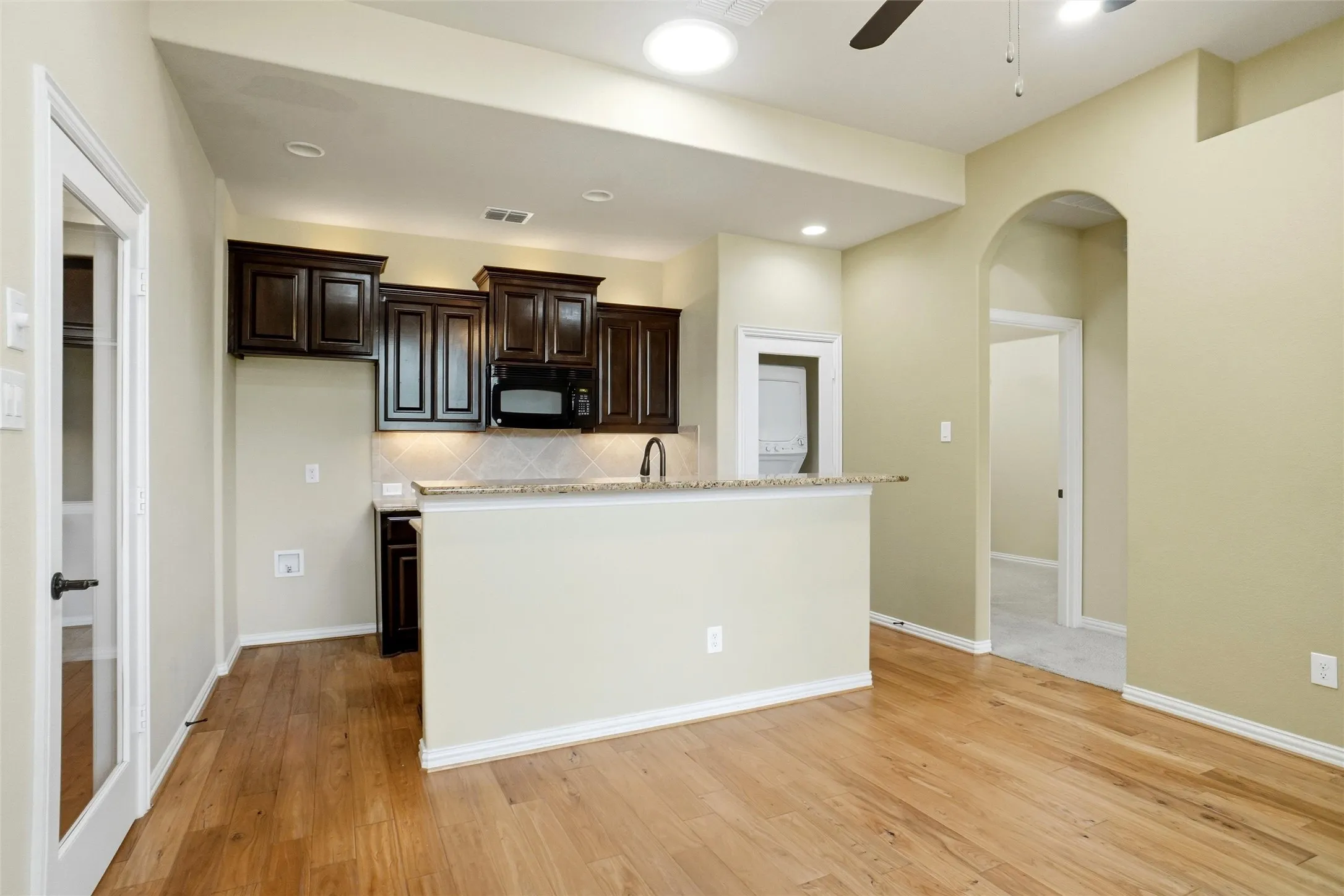 In-Law Suite kitchen with stackable washer and dryer, microwave.