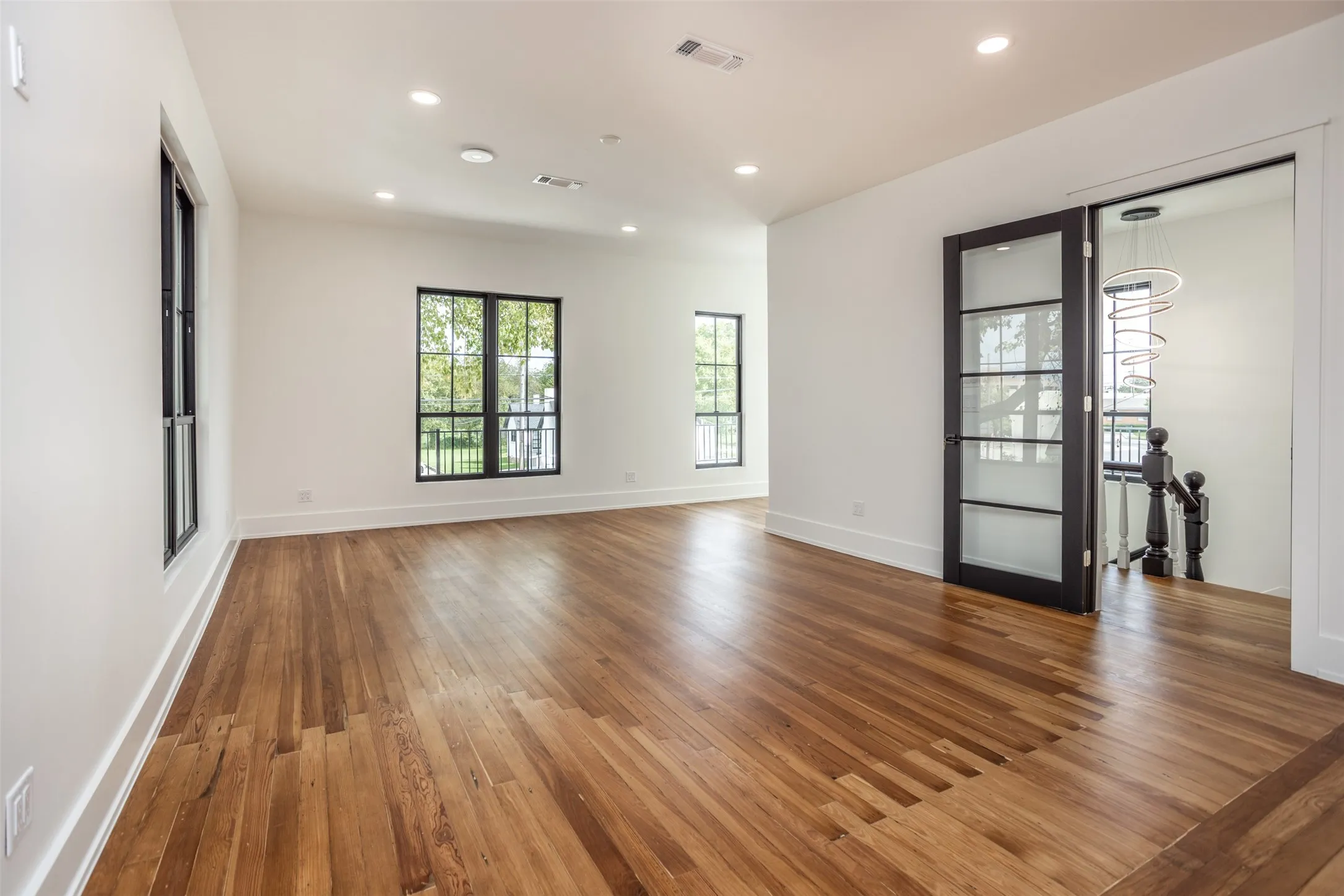 Interior space featuring wood-finish flooring, recessed lighting, and expansive windows