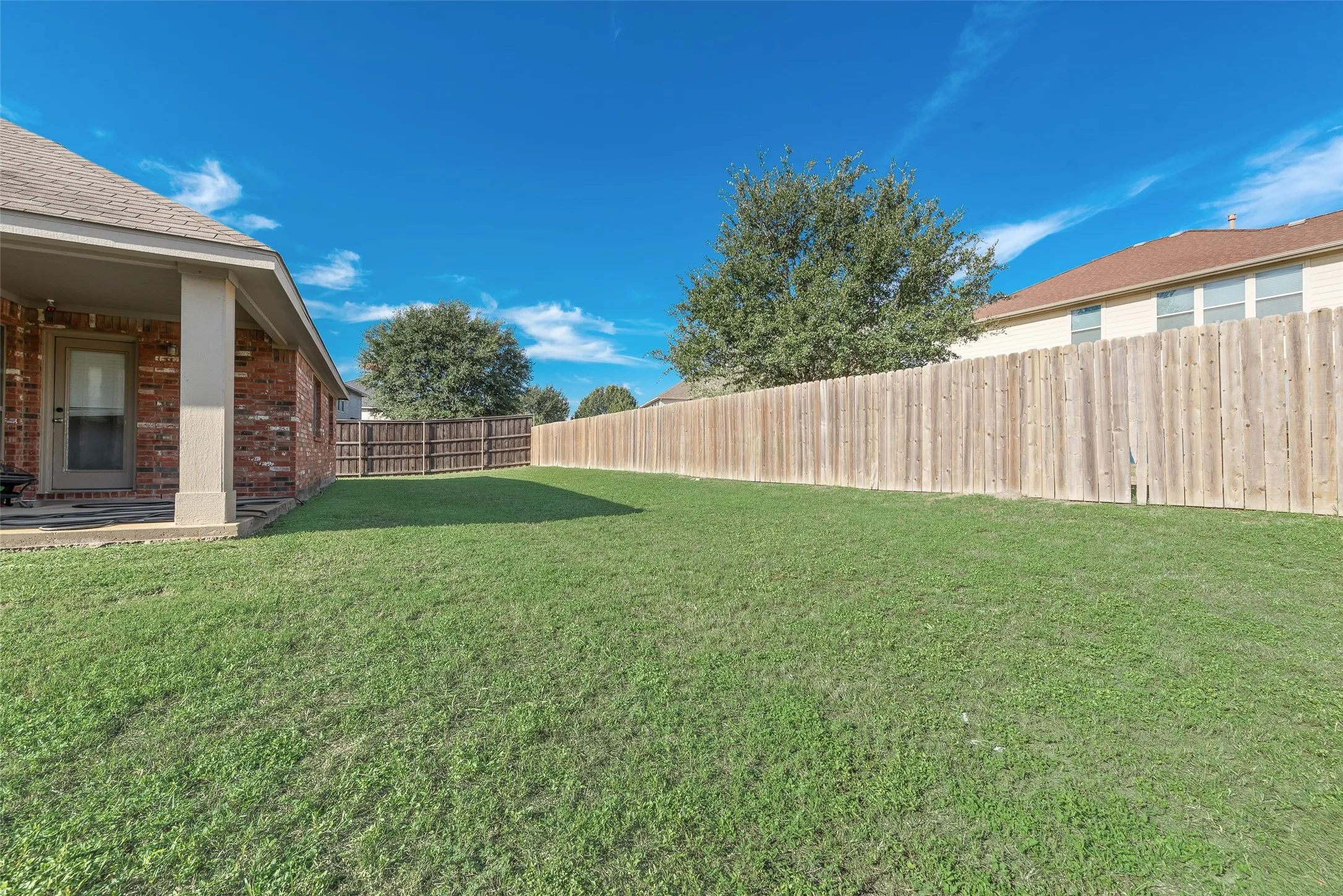  The HUGE yard is perfect for entertaining! It also features a covered patio, perfect for grilling!