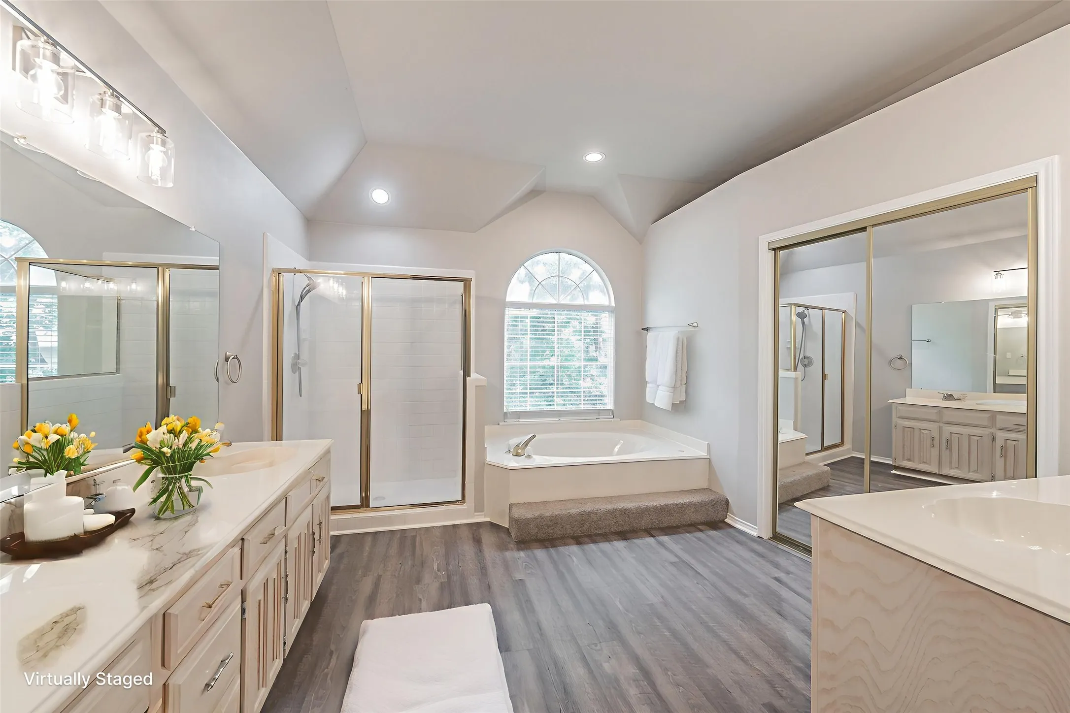 Large primary en suite bathroom with separate shower, jetted tib and large walk in closet