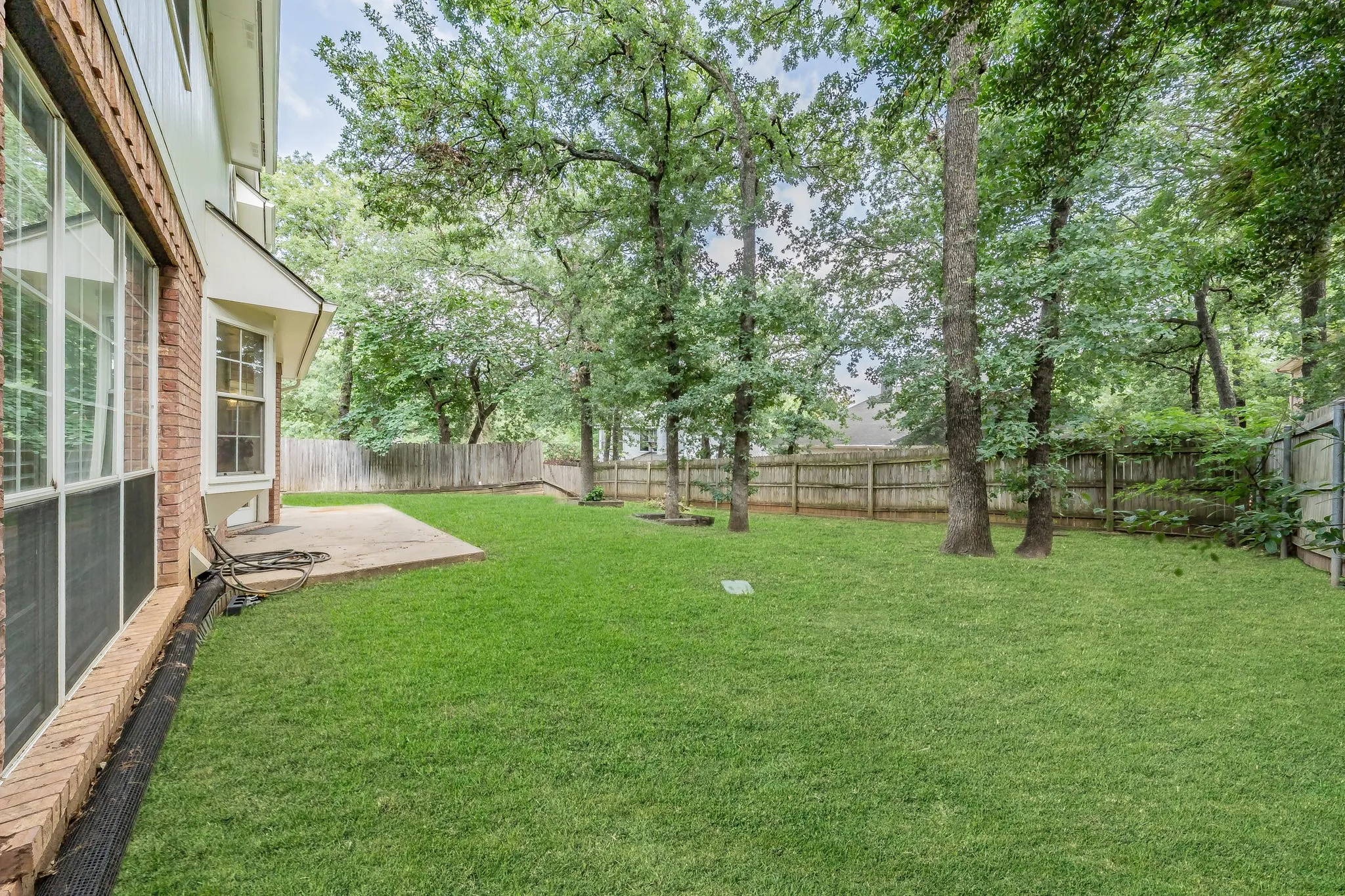 Spacious backyard with beautiful shade trees awaiting your family.