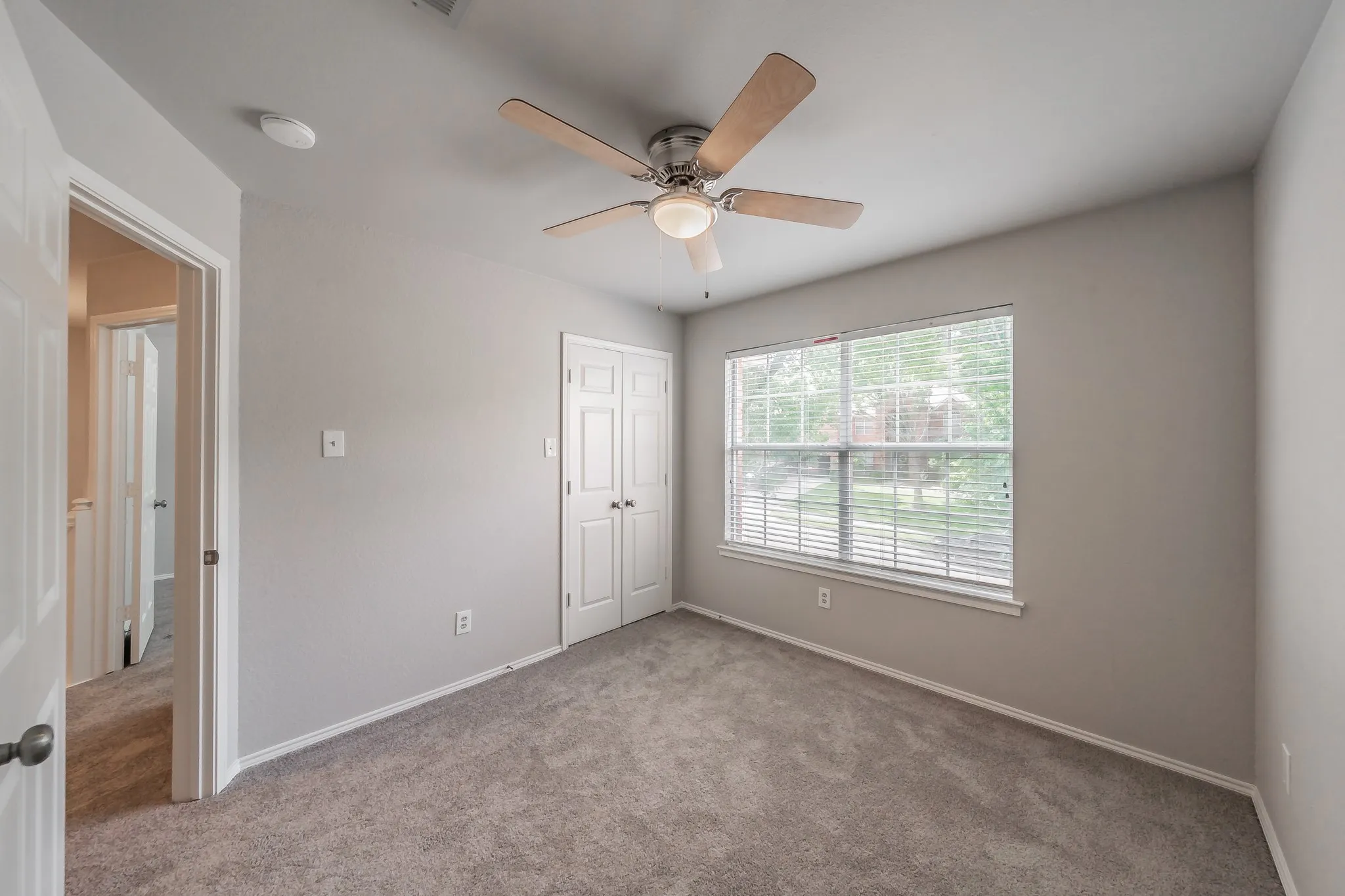 Secondary bedrooms feature carpet, ceiling fans and blinds.