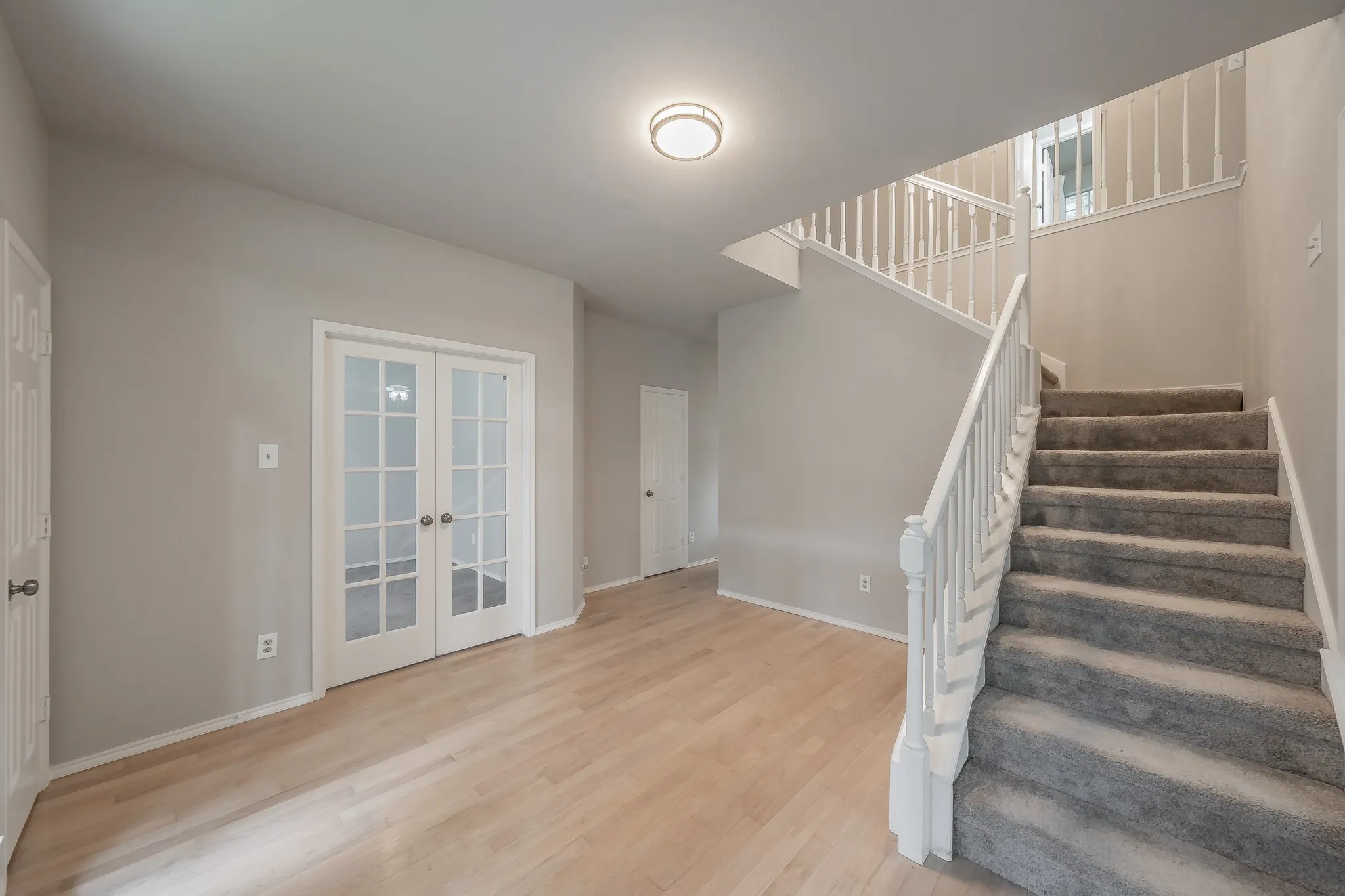 Entryway opens to office and stairway leading upstairs.