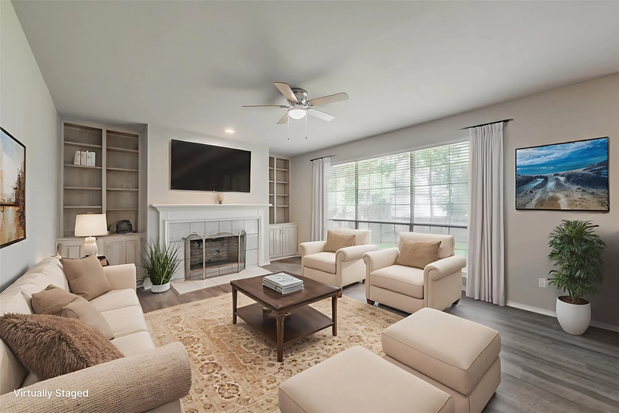 Virtually staged family room with wood burning fireplace ready for cozy evenings flanked by built in shelves & cabinets offering additional storage.