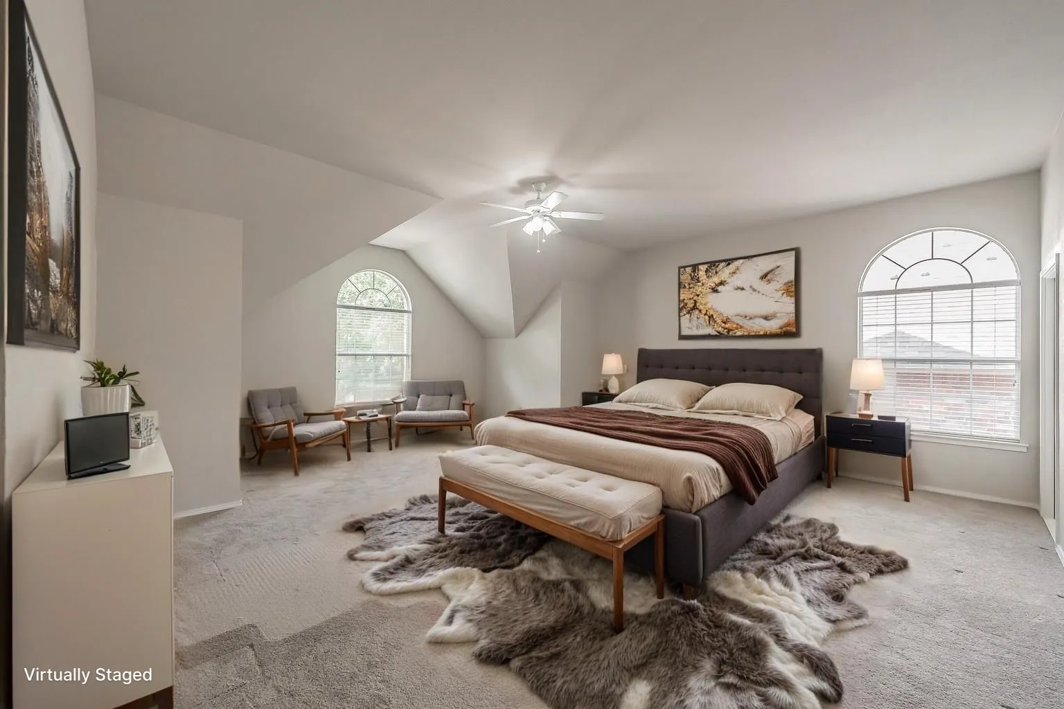 Virtually staged oversized primary bedroom with space for seating area.