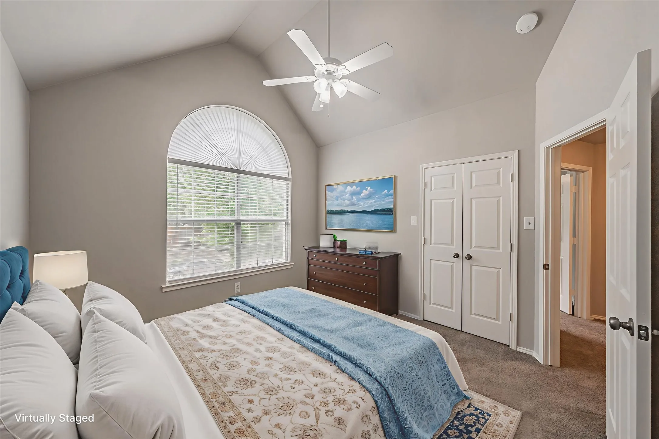 Virtually staged bedroom with vaulted ceiling.
