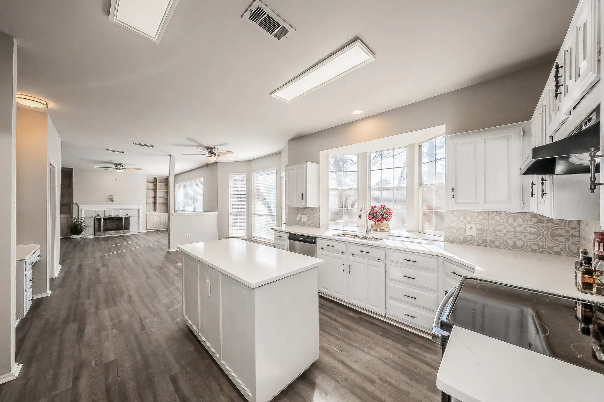 Large kitchen featuring large island & beautiful quartz counters is open to breakfast area & family room.