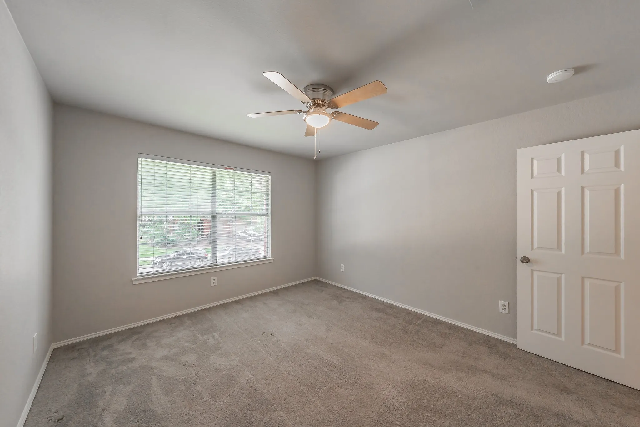 Secondary bedrooms feature carpet, ceiling fans and blinds.
