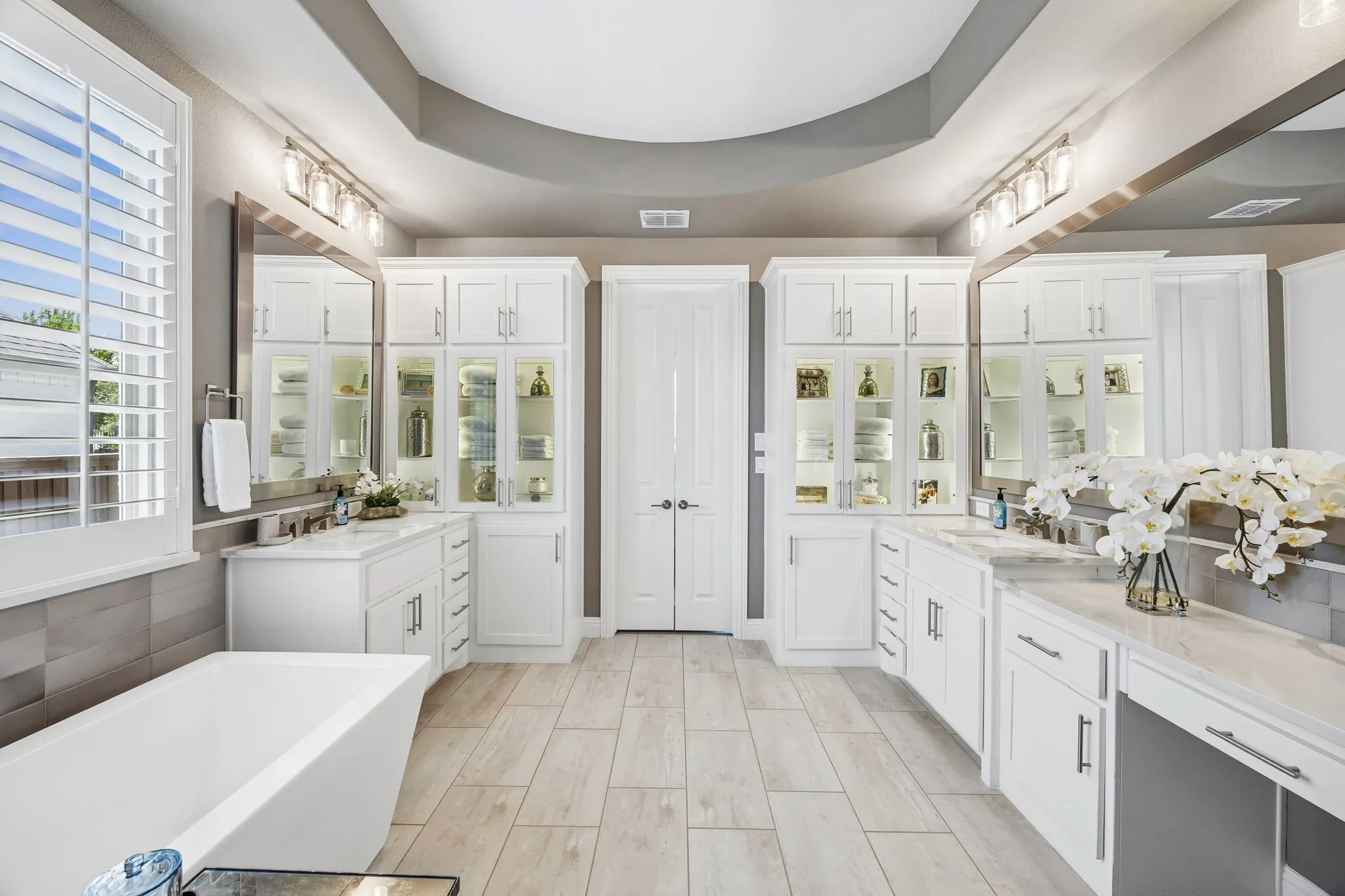 The gorgeous master suite offers tons of backlit cabinetry, high end quartz counters, soaking free standing tub and lots of natural light!