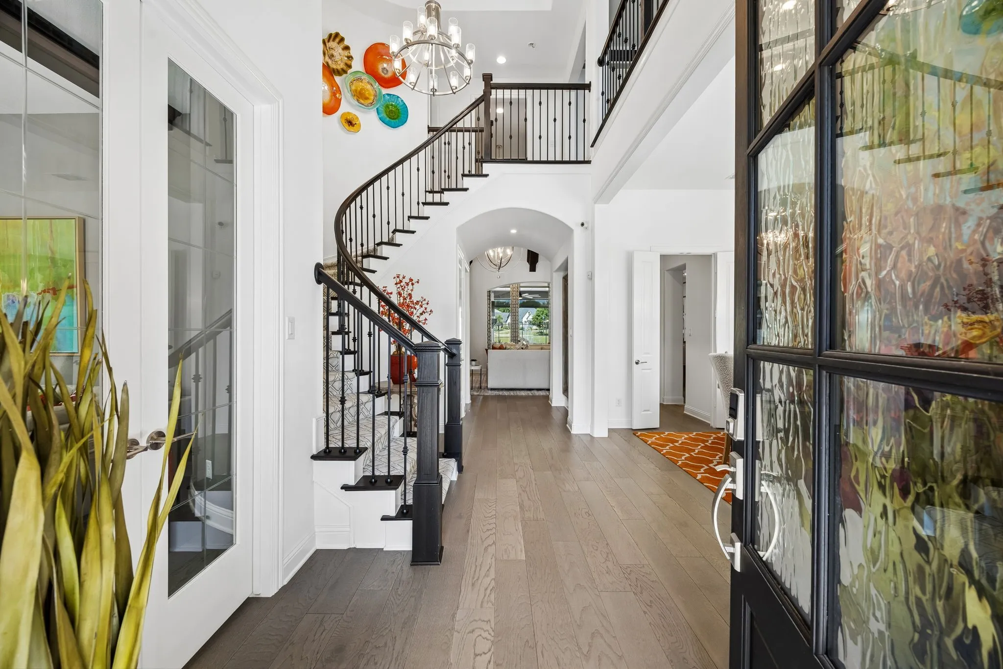 Stunning wood floor entry with winding staircase. Entry is flanked by elegantly designed study and formal dining room.