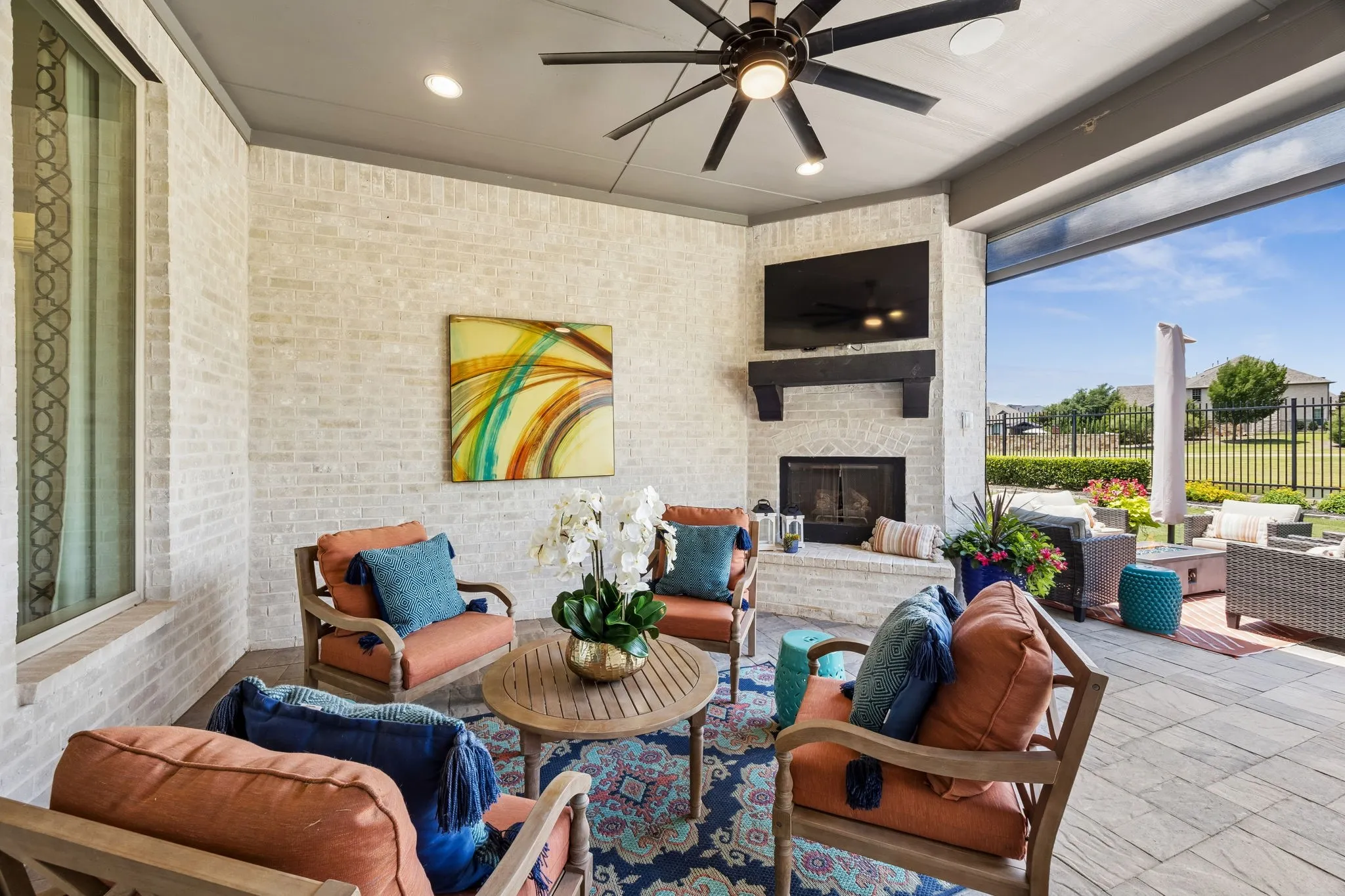Covered back paito with fireplace and electric sun screens make this the ideal exterior space all year long.