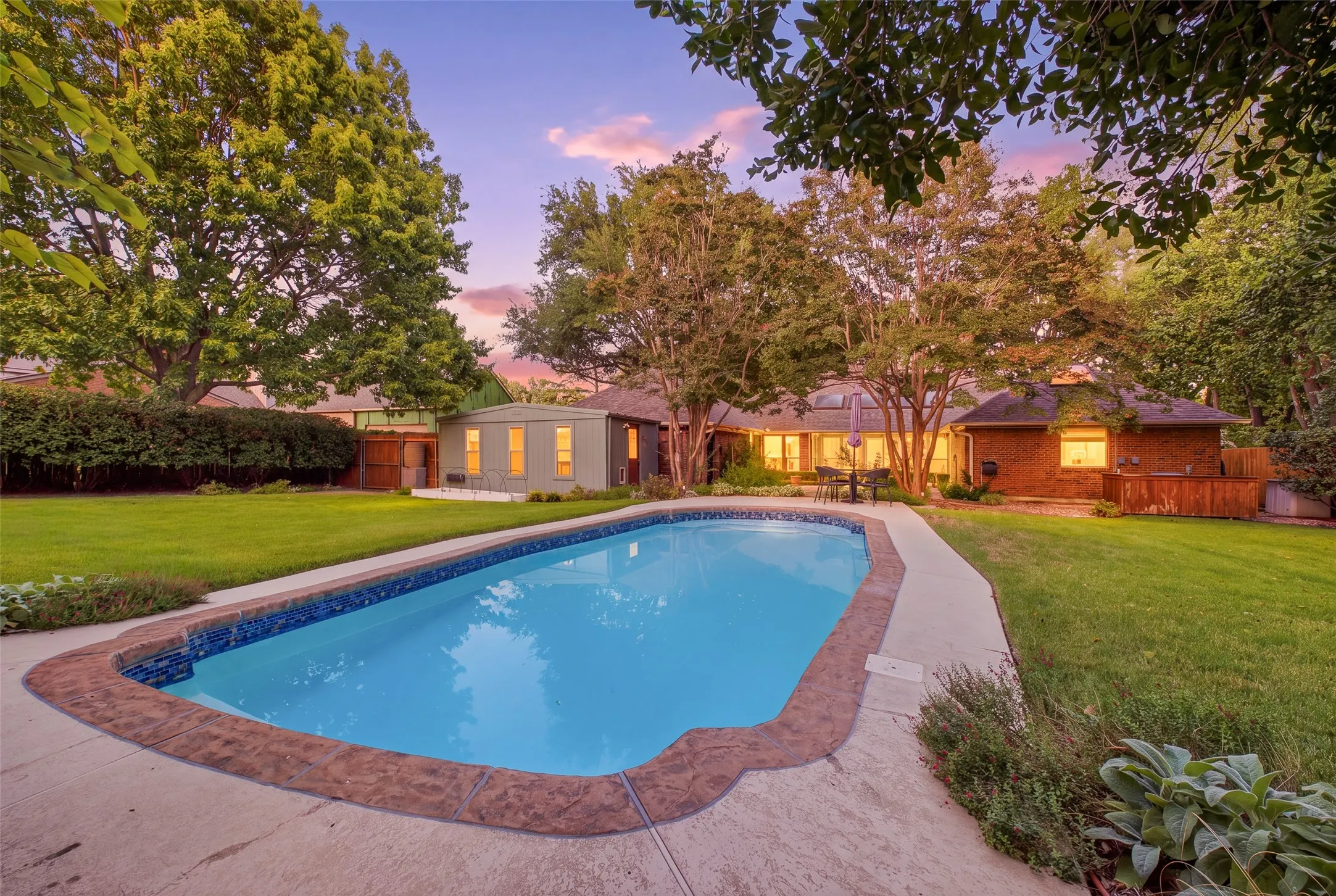 Backyard resort living: a sparkling pool, sweeping lawn and golden-hour views right outside your door.