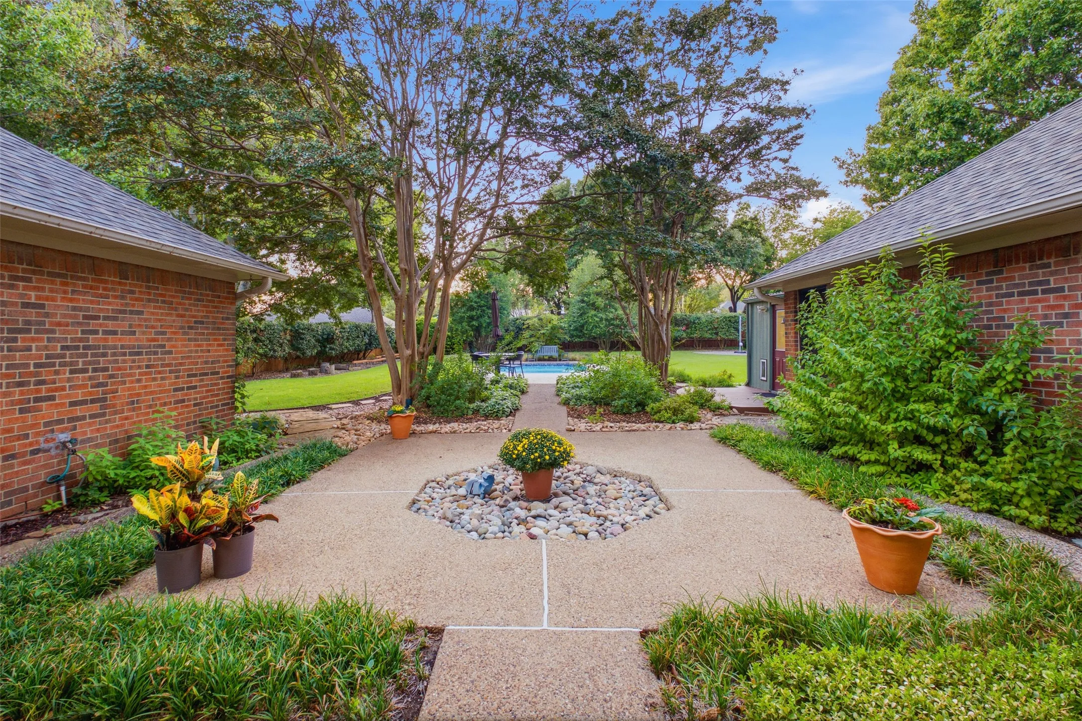 Private courtyard with river-rock accents, mature landscaping and room to unwind.