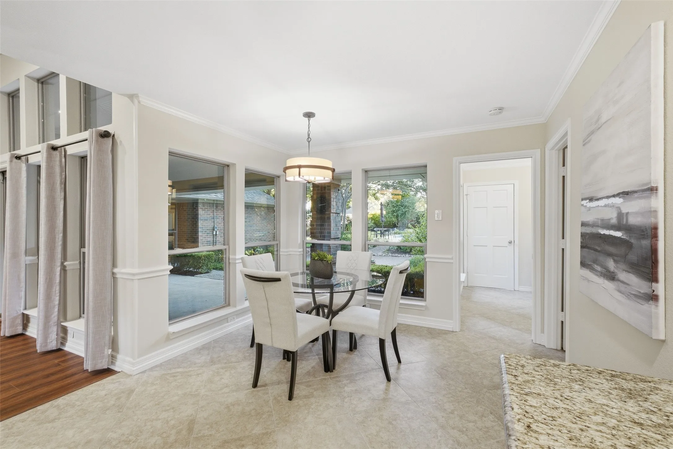 Sun-drenched breakfast nook surrounded with windows on: a bright spot for slow mornings and courtyard views.