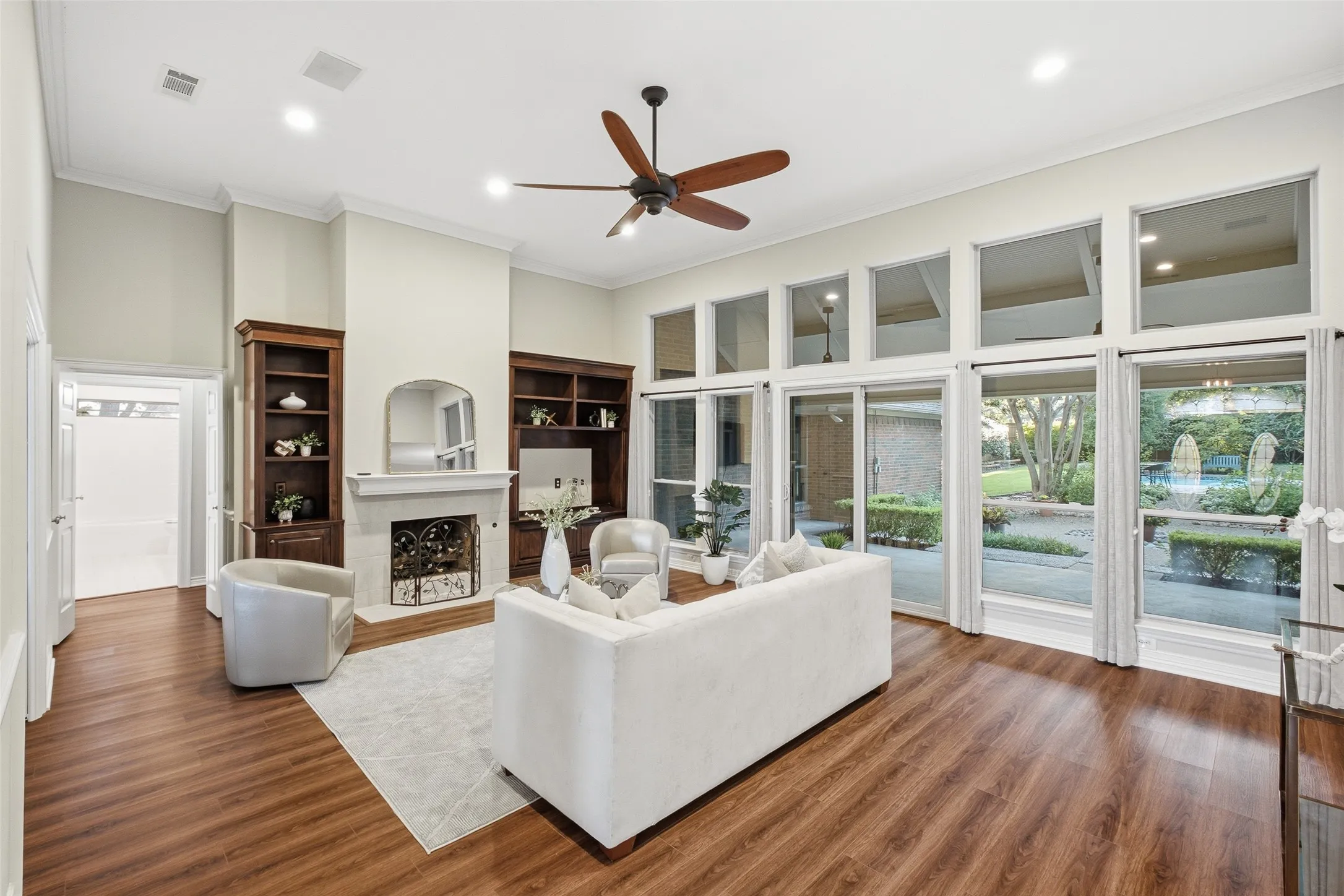 Soaring ceilings, a stately fireplace and custom built-in cabinetry make this living room the heart of the home.