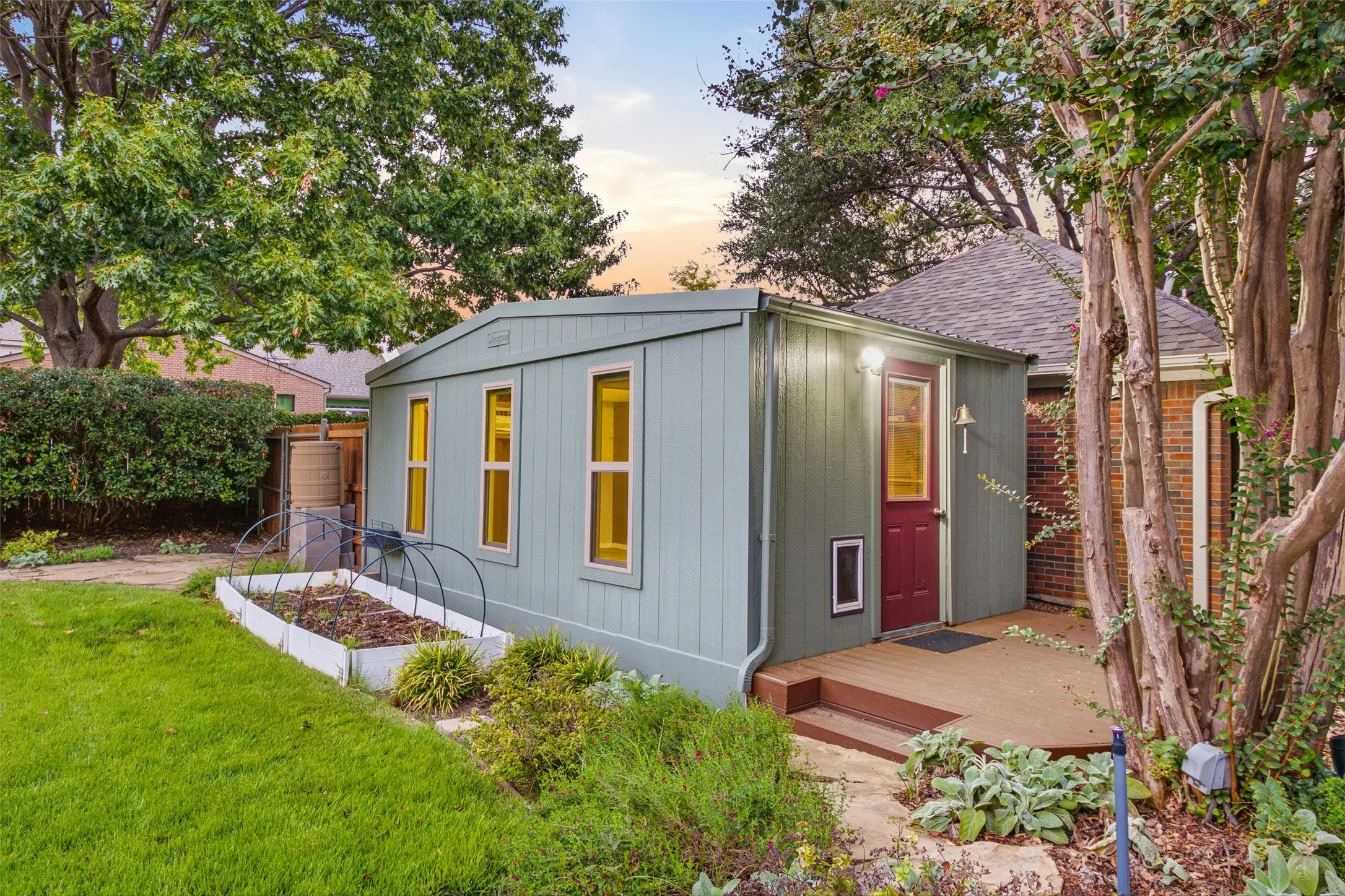 Detached backyard studio with deck entry: workshop, hobby space, home office or creative retreat.