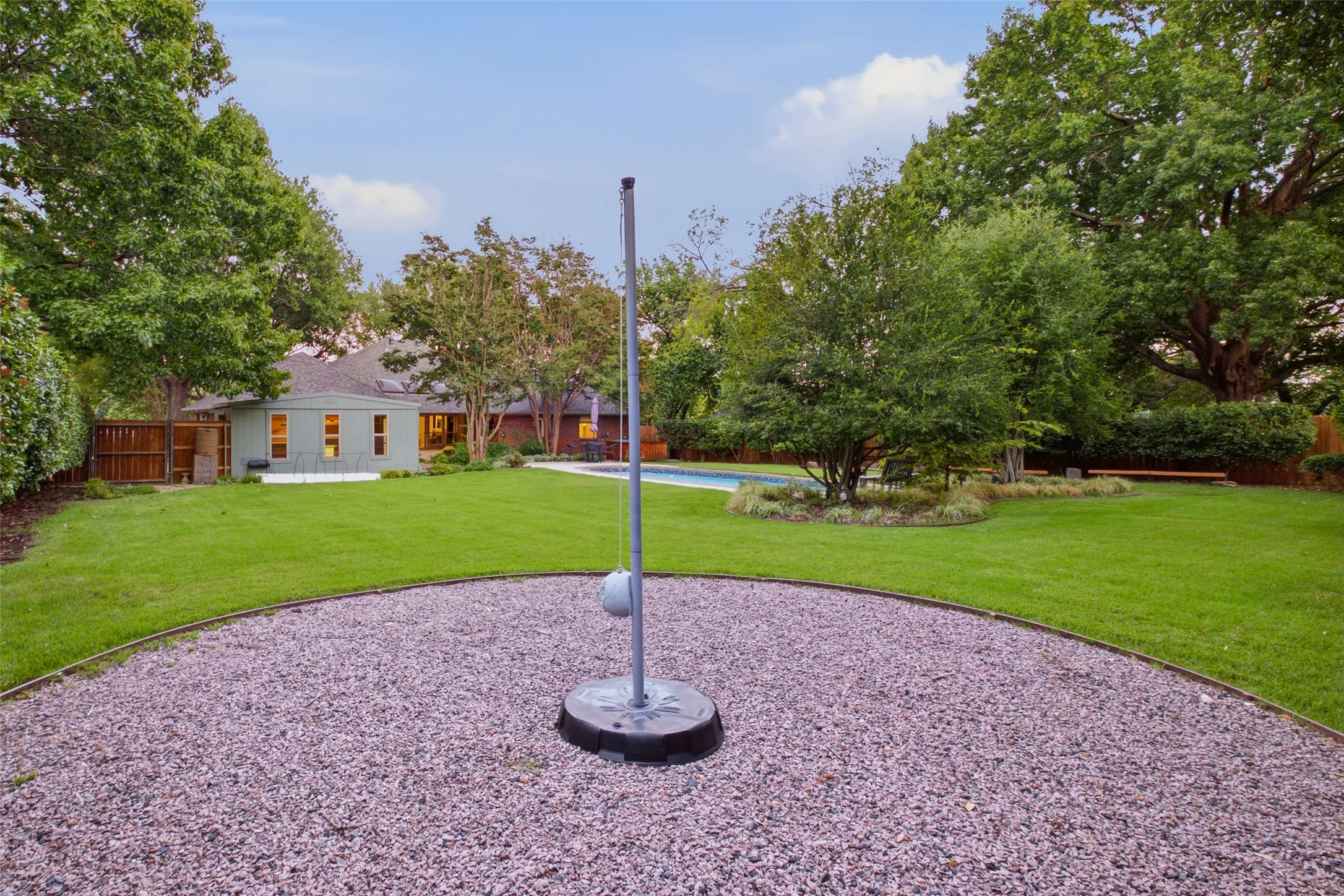 Gravel game court sits ready for backyard fun and weekend competition.