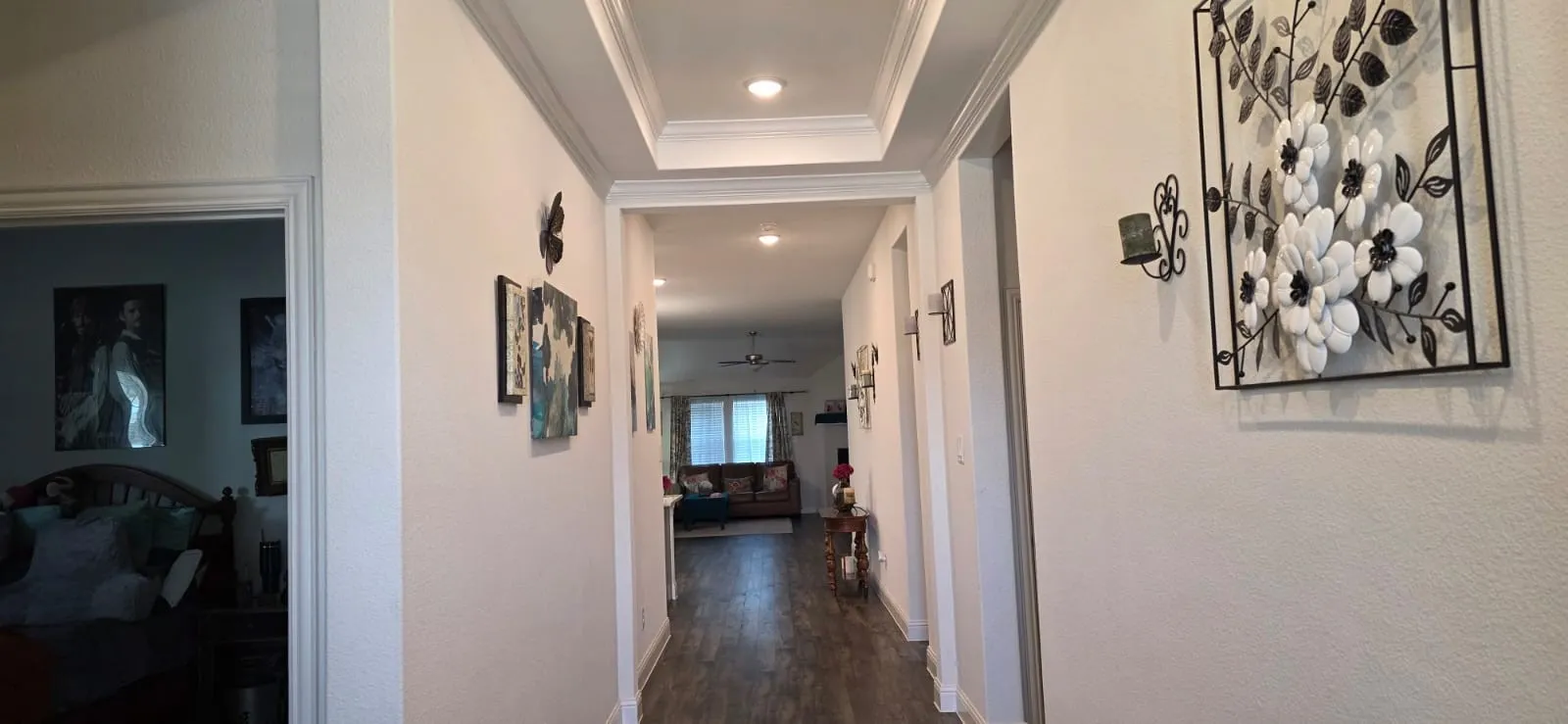 Hallway featuring a coffered ceiling with recessed lighting, wood-finish flooring, and white trim