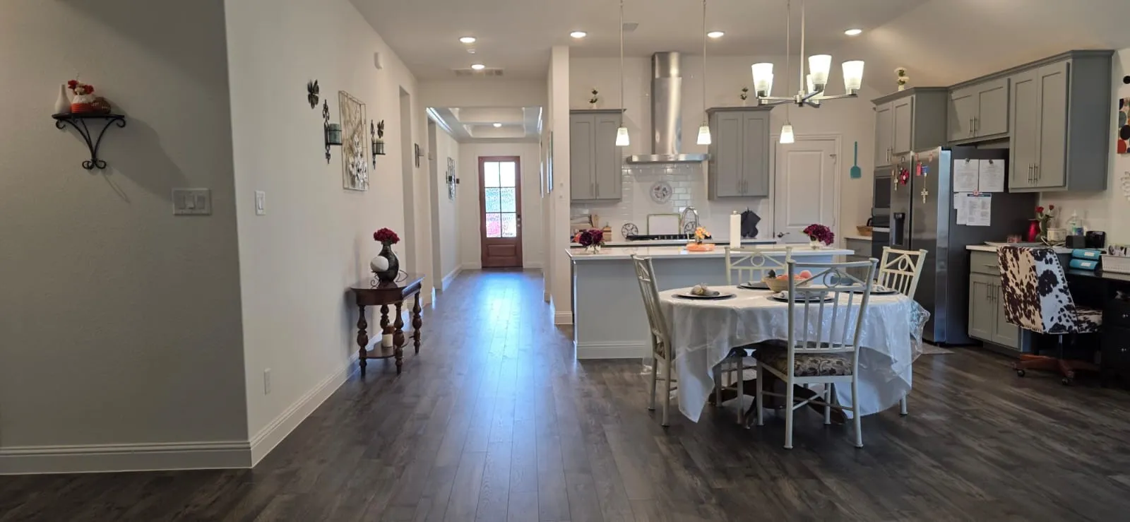 Open-concept kitchen and dining area featuring wood-finish flooring