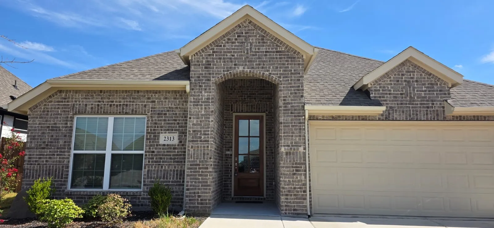 Brick exterior facade with an arched entry