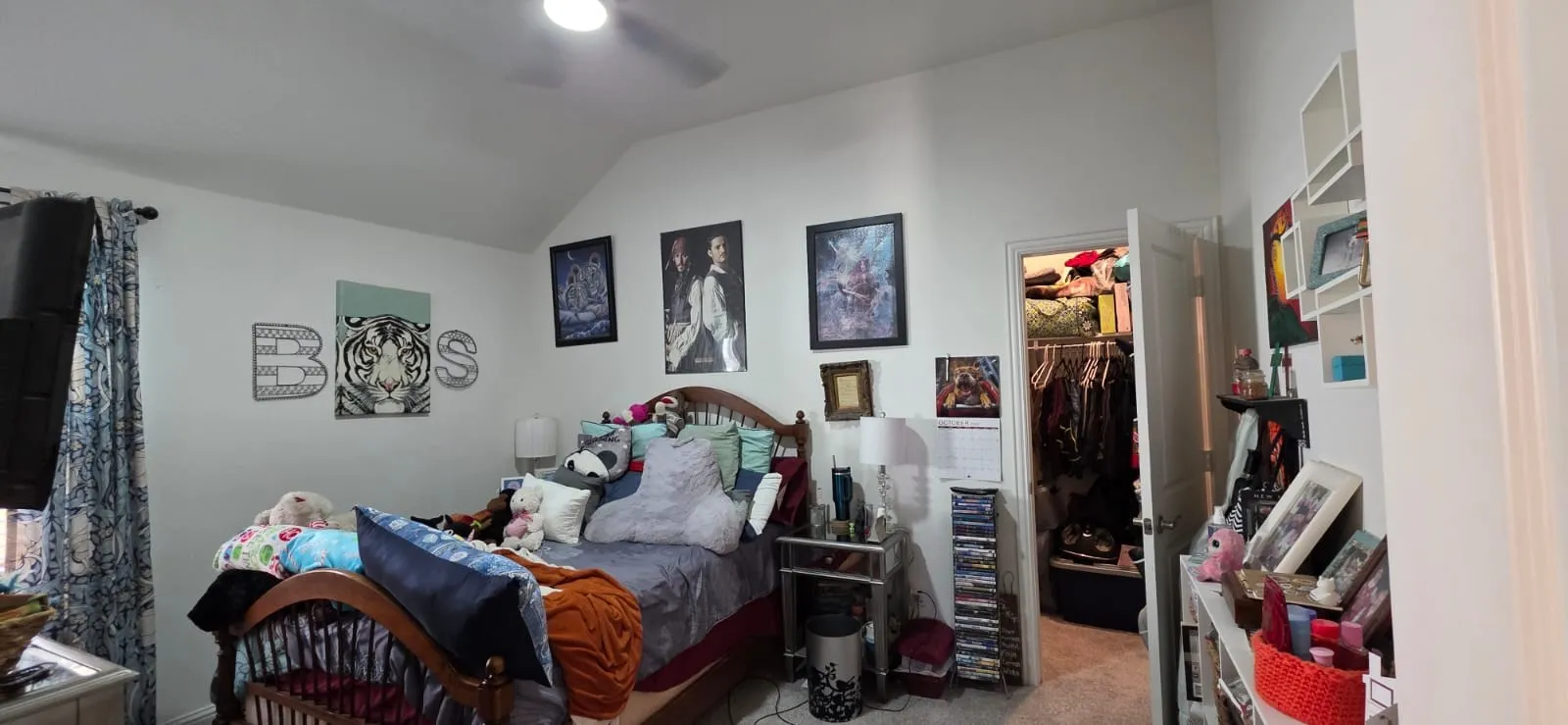 brm3 Vaulted ceiling with a ceiling fan, white walls, and a built-in closet with an open door