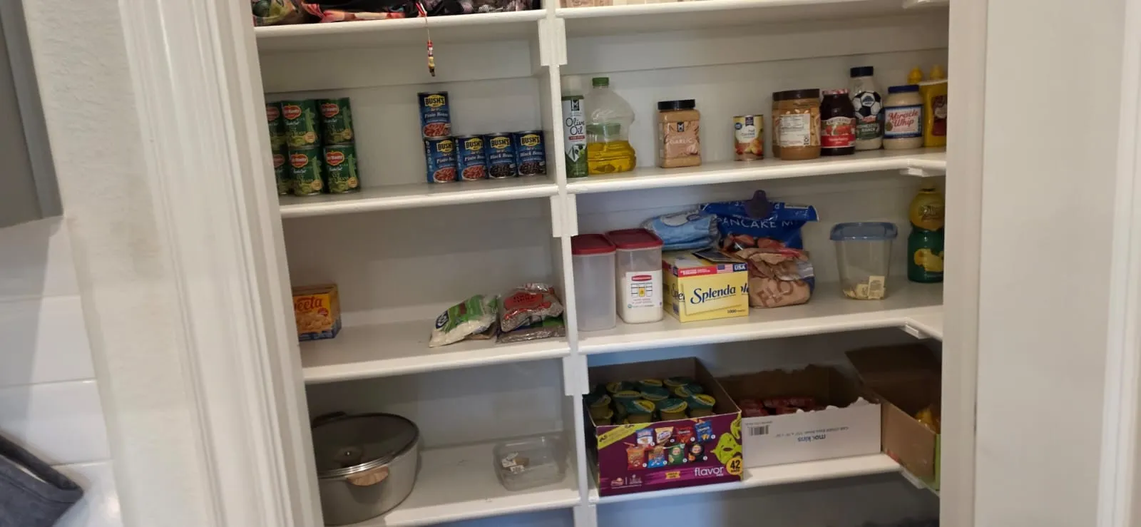 Built-in pantry shelving provides extensive storage