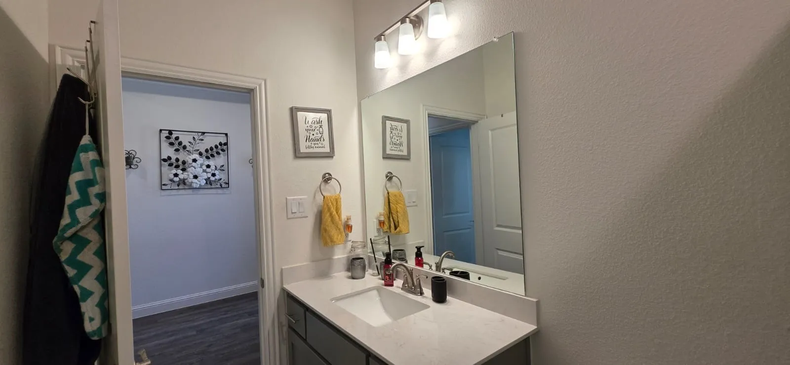Bath 3 Vanity with a single basin, stainless steel faucet, and overhead lighting fixture