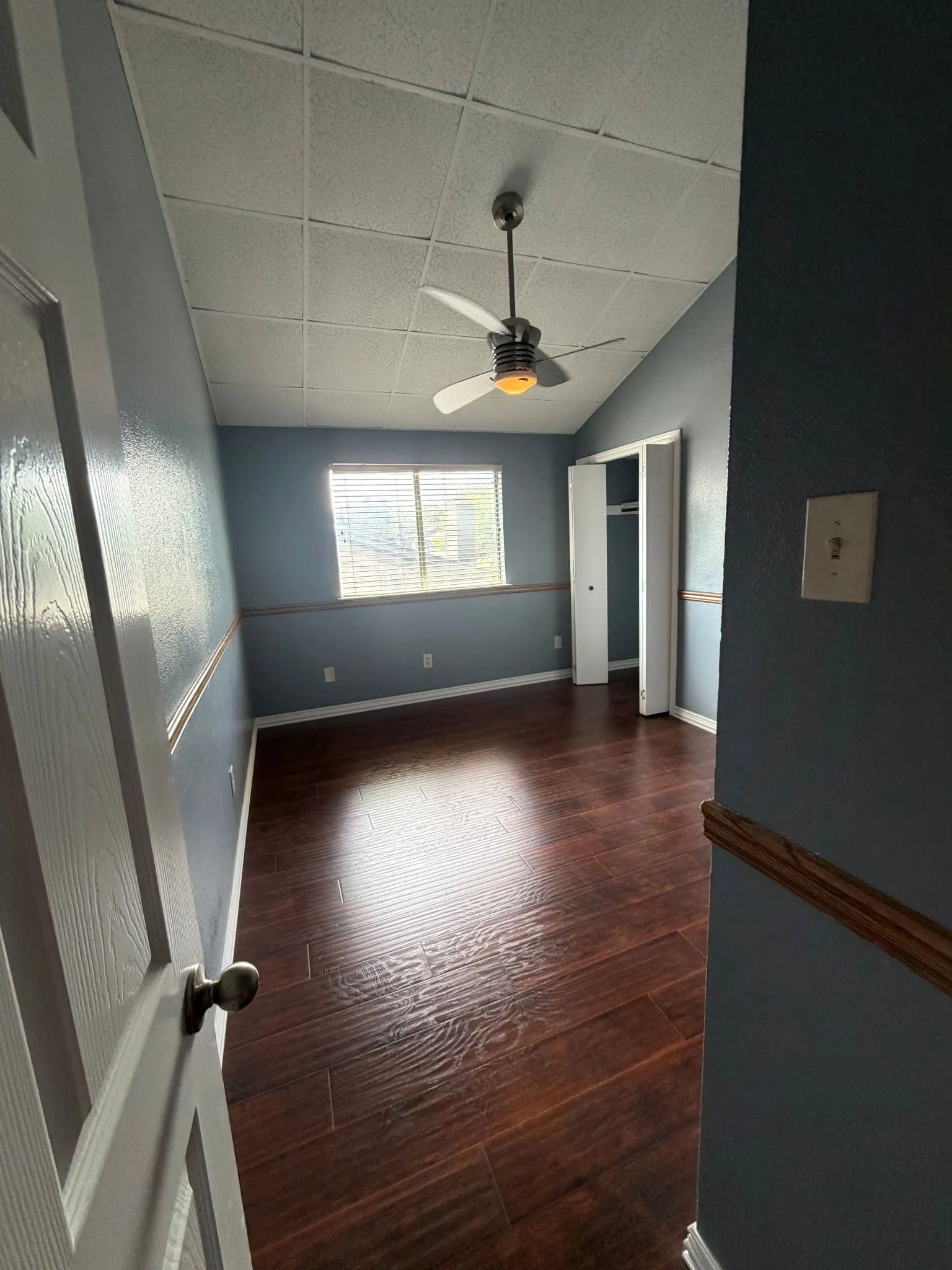 Bed Room two upstairs featuring vaulted ceilings, wood-finish flooring, a ceiling fan with integrated lighting, and a closet with bifold doors