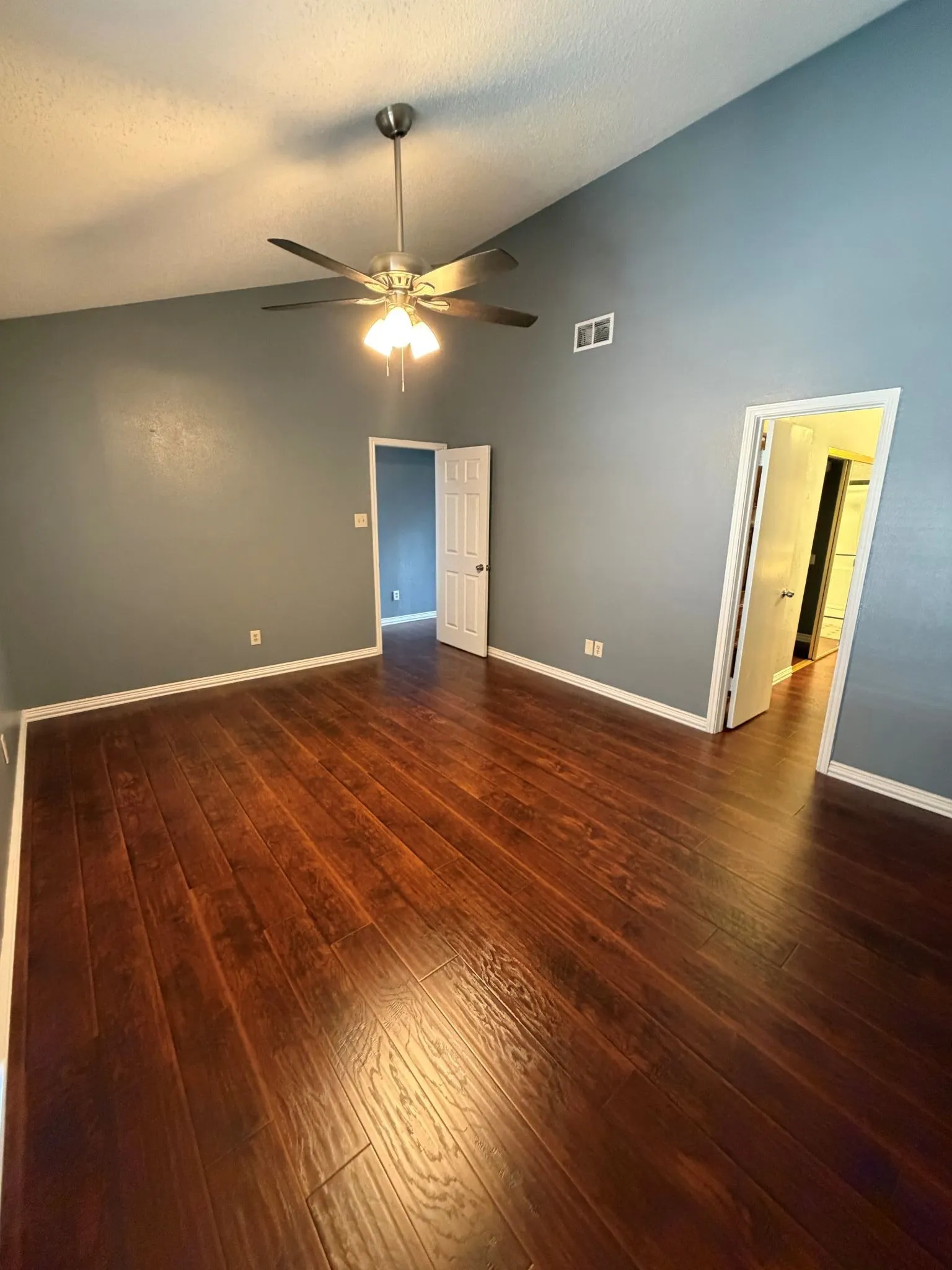primary bedroom with ensuite bathroom, ceiling fan & two closets upstairs