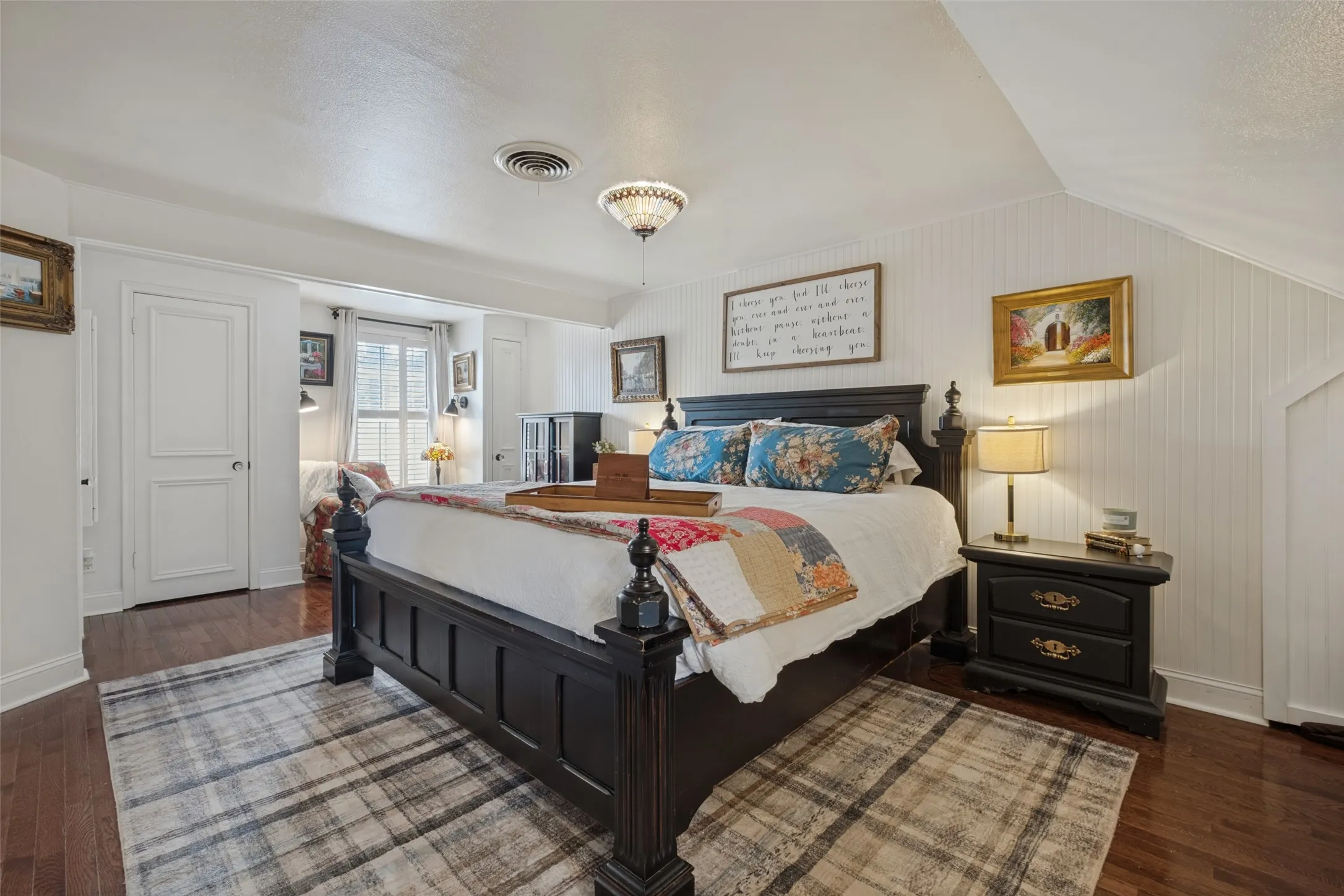 Beadboard wainscoting, wood-finish flooring, and semi-flush mount lighting