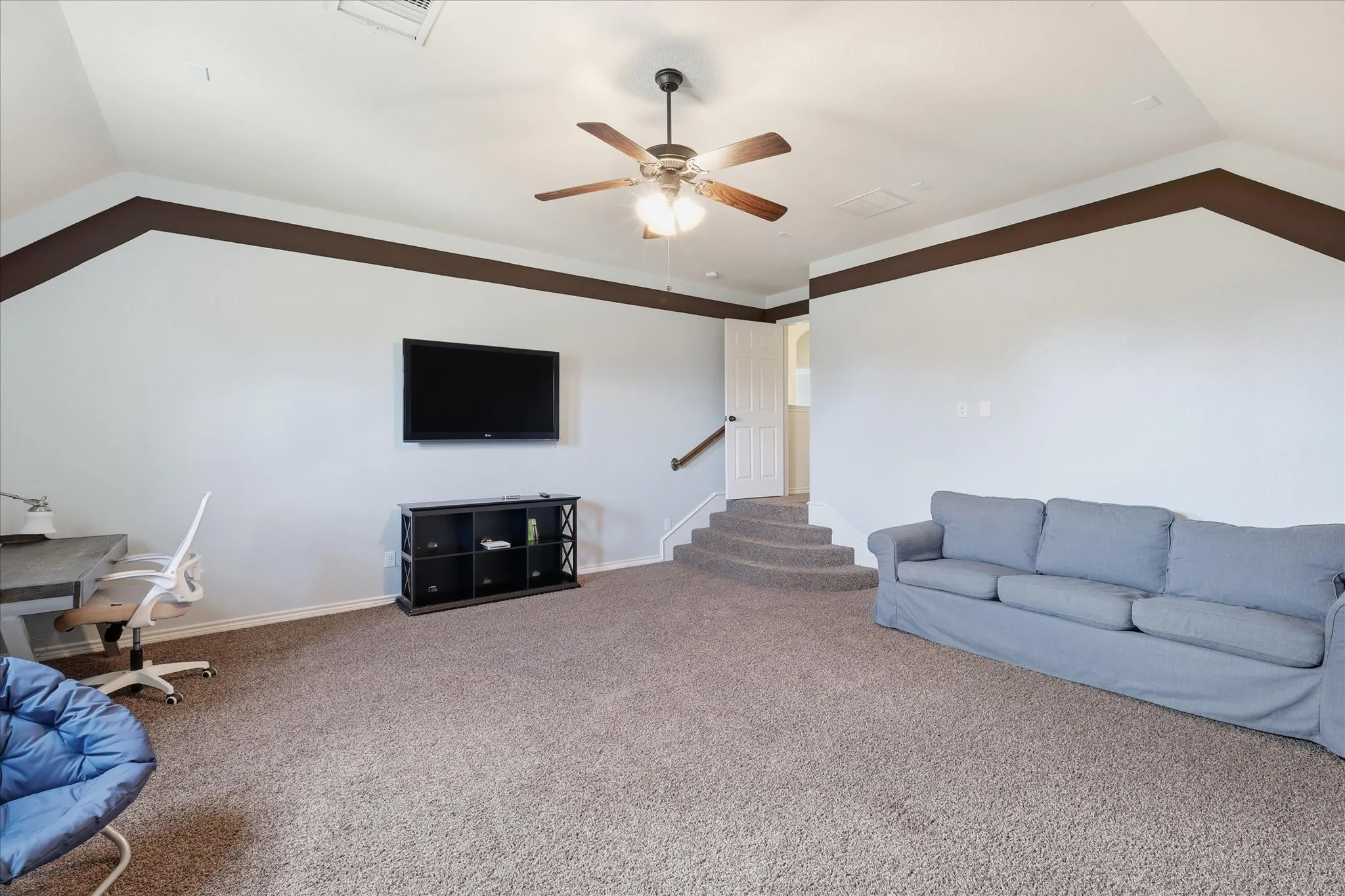 Vaulted ceilings, carpeting, and decorative wall molding