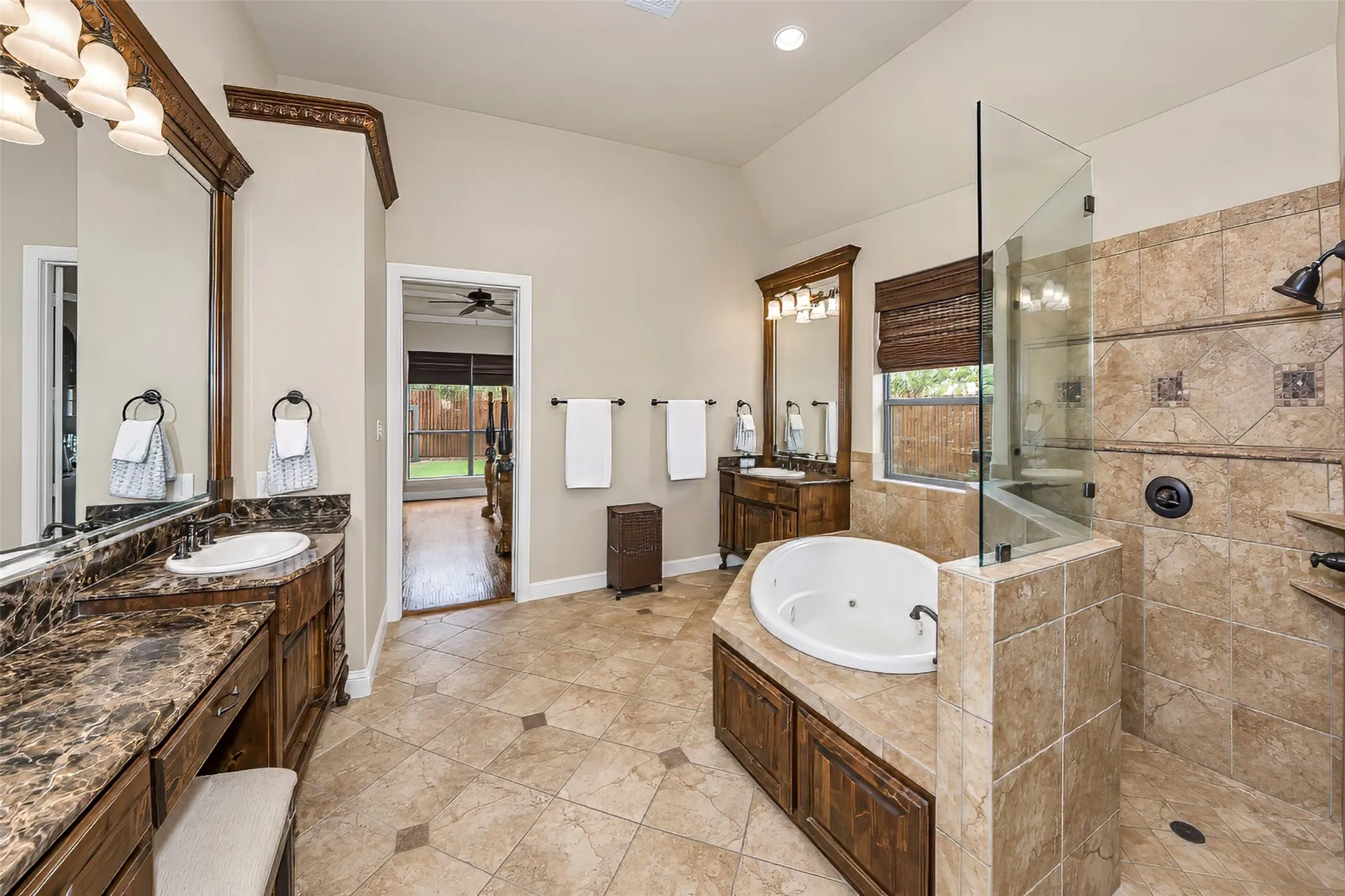 The ensuite primary bath features a walk in shower, separate vanities and tub.