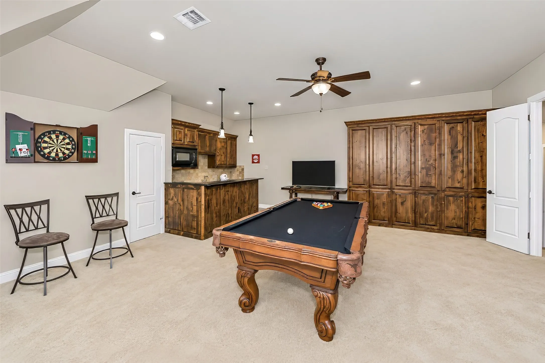 This huge room is equipped with a wet bar and built in cabinets, large enough for a full sized pool table and furniture.