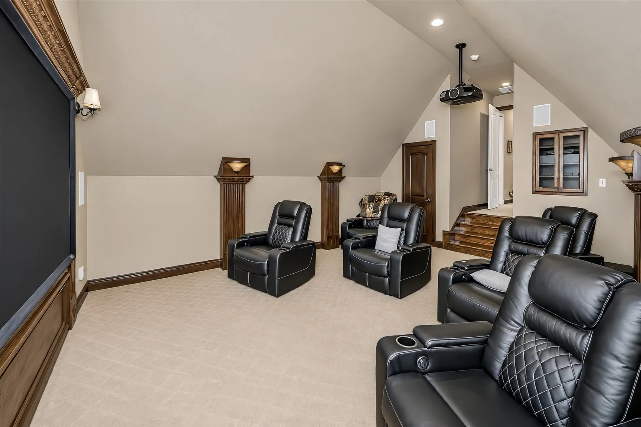 Large media room equipped with professionally installed projection and sound equipment.
