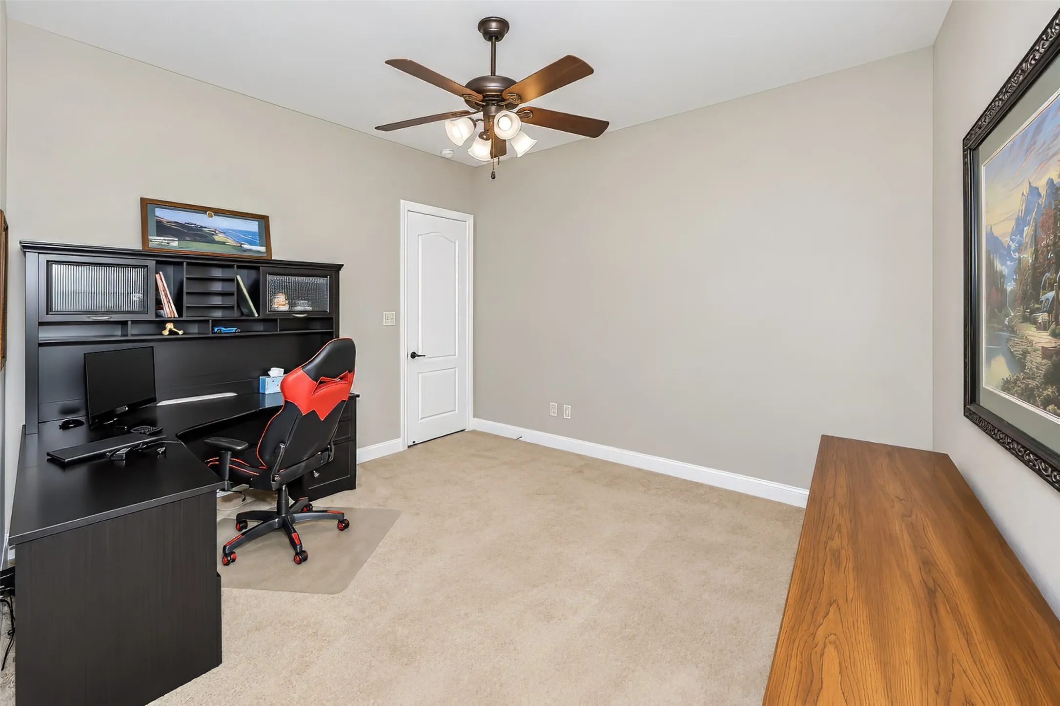 An upstairs guest bedroom is currently used an an office.