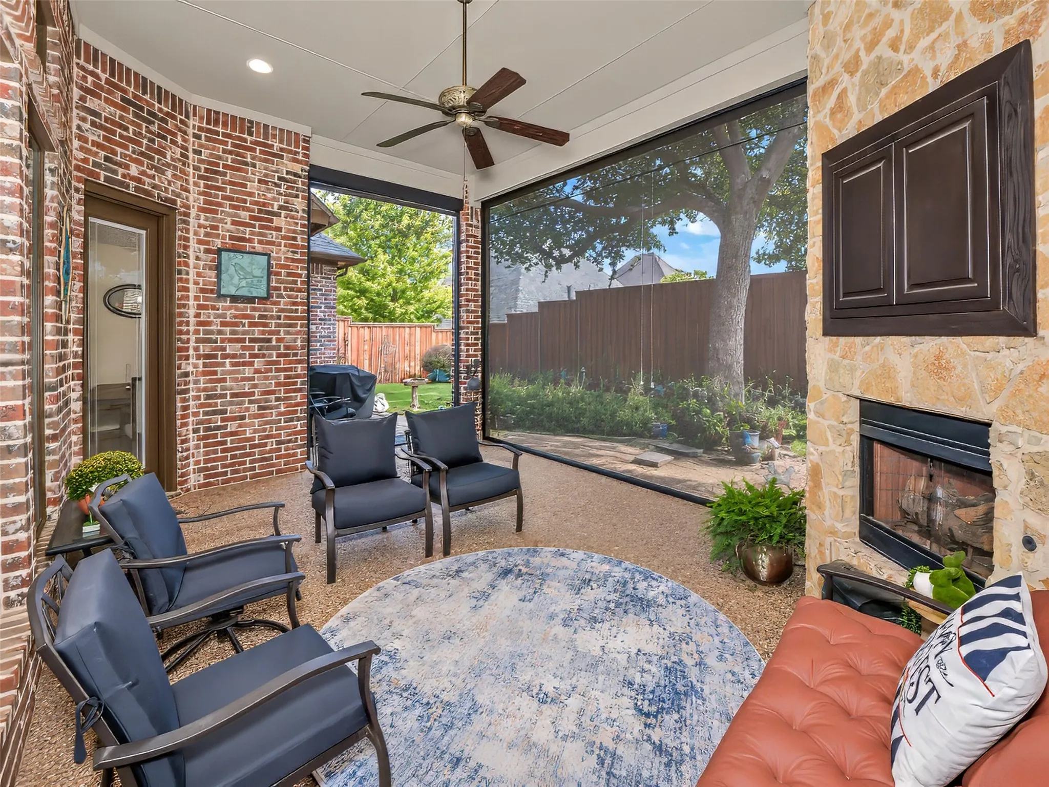 The covered patio is equipped with remote controlled screening for added comfort during the warm weather.
