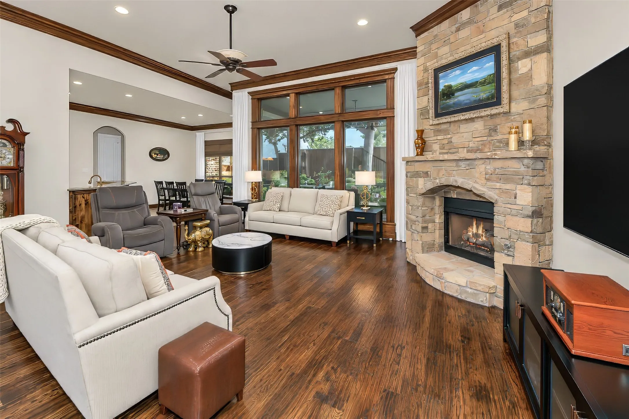 The great room features a beautiful stone fireplace and gas logs.