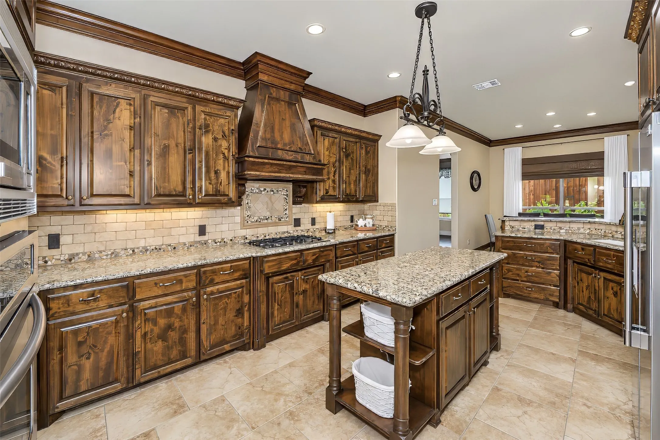 The gourmet kitchen features stone countertops and upgraded appliances.