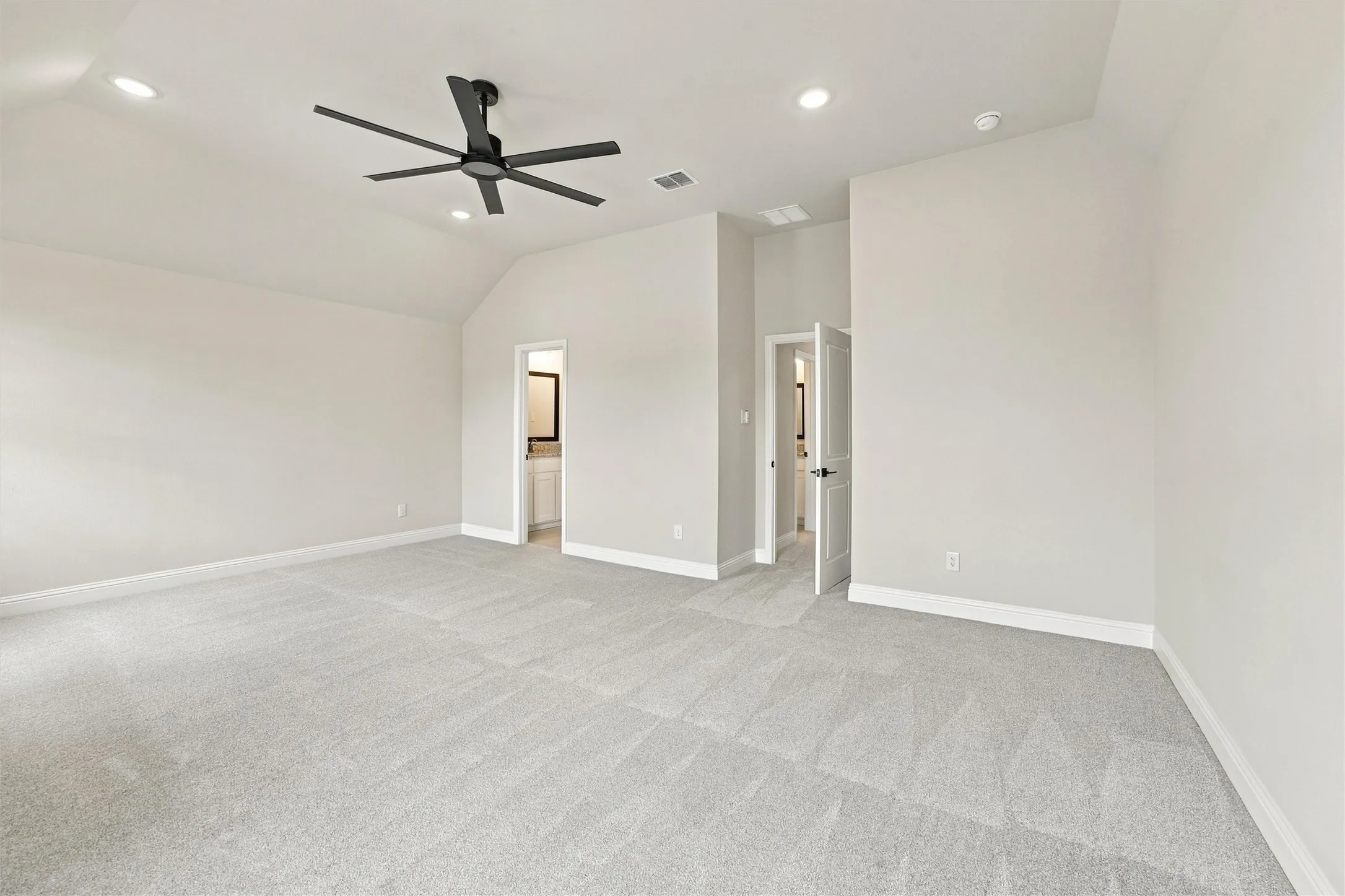 Vaulted ceilings featuring recessed lighting and a multi-blade ceiling fan, wall-to-wall carpeting, and multi-panel interior doors
