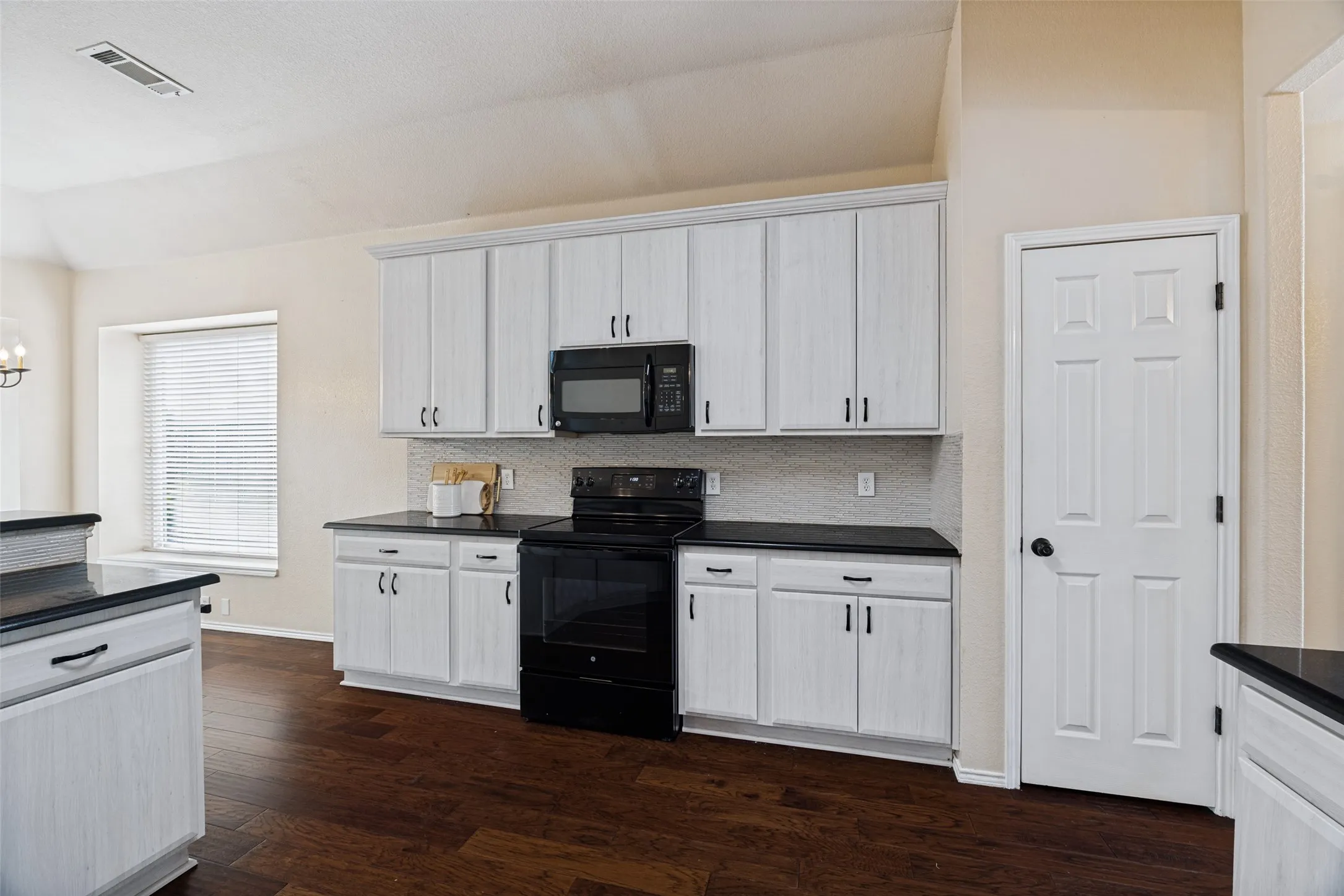 Kitchen featuring new cabinets and granite counters