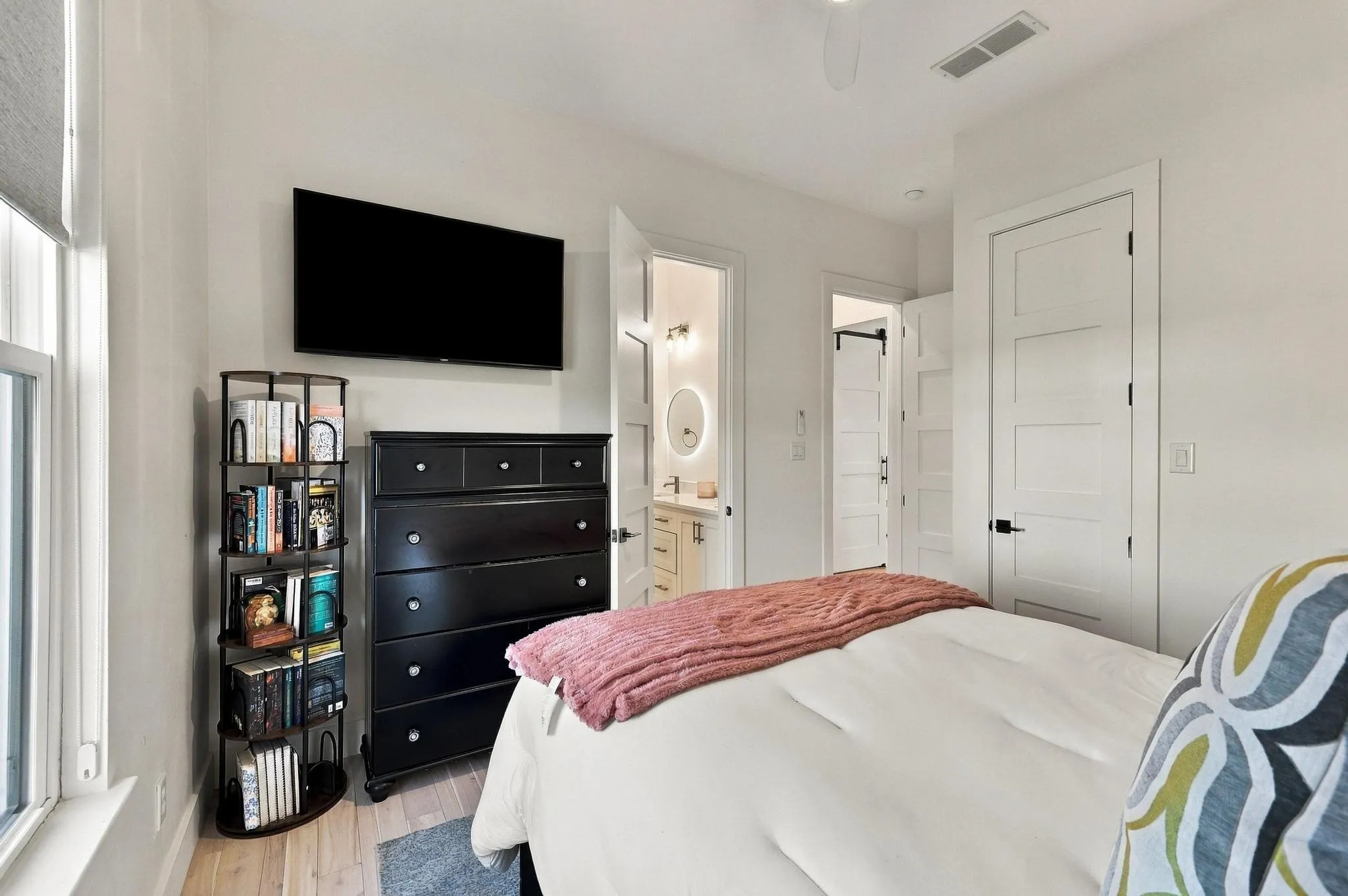Four-panel interior doors with matte black hardware, light-toned wood-finish flooring, and neutral wall color