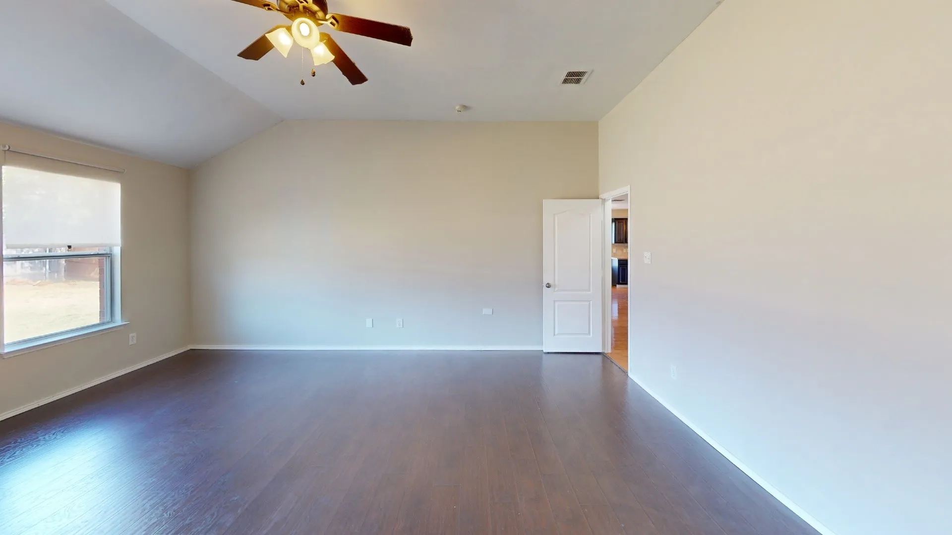 Vaulted ceilings, wood-finish flooring, and a ceiling fan with integrated lighting