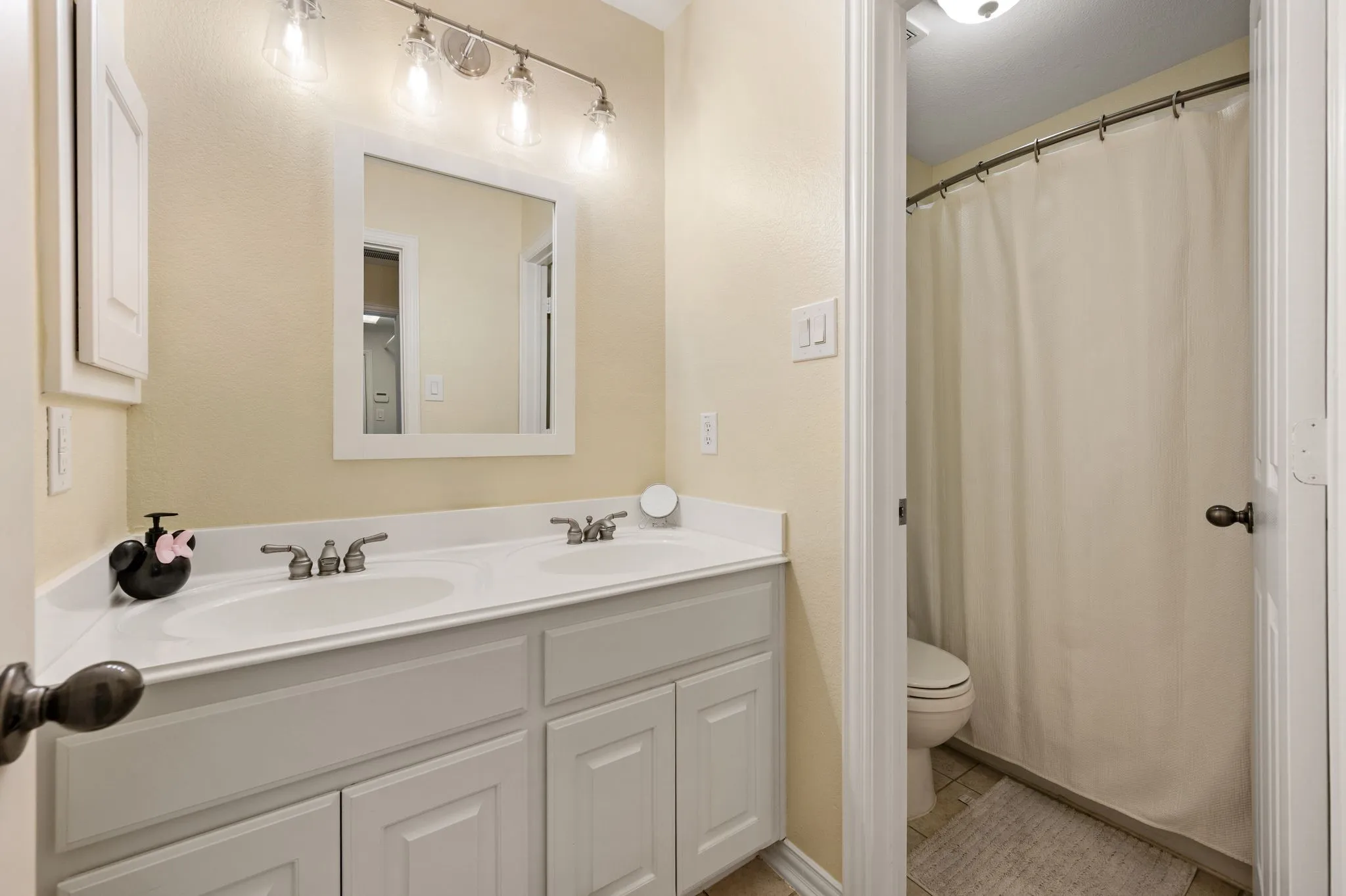 First floor secondary bath has two sinks