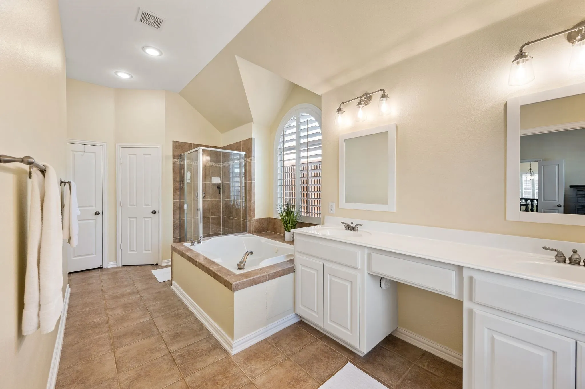 Primary suite has shower and soaking tub, dual sinks, linen closet and spacious walk in closet