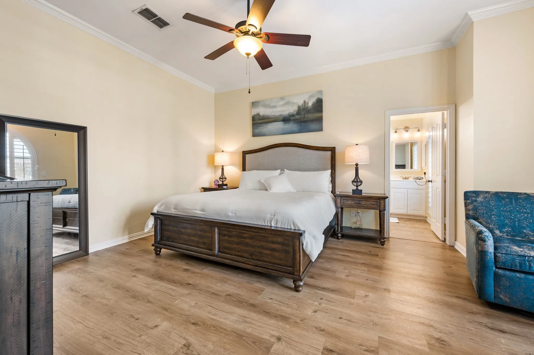 Recently added wood tone luxury vinyl plank flooring in the primary suite