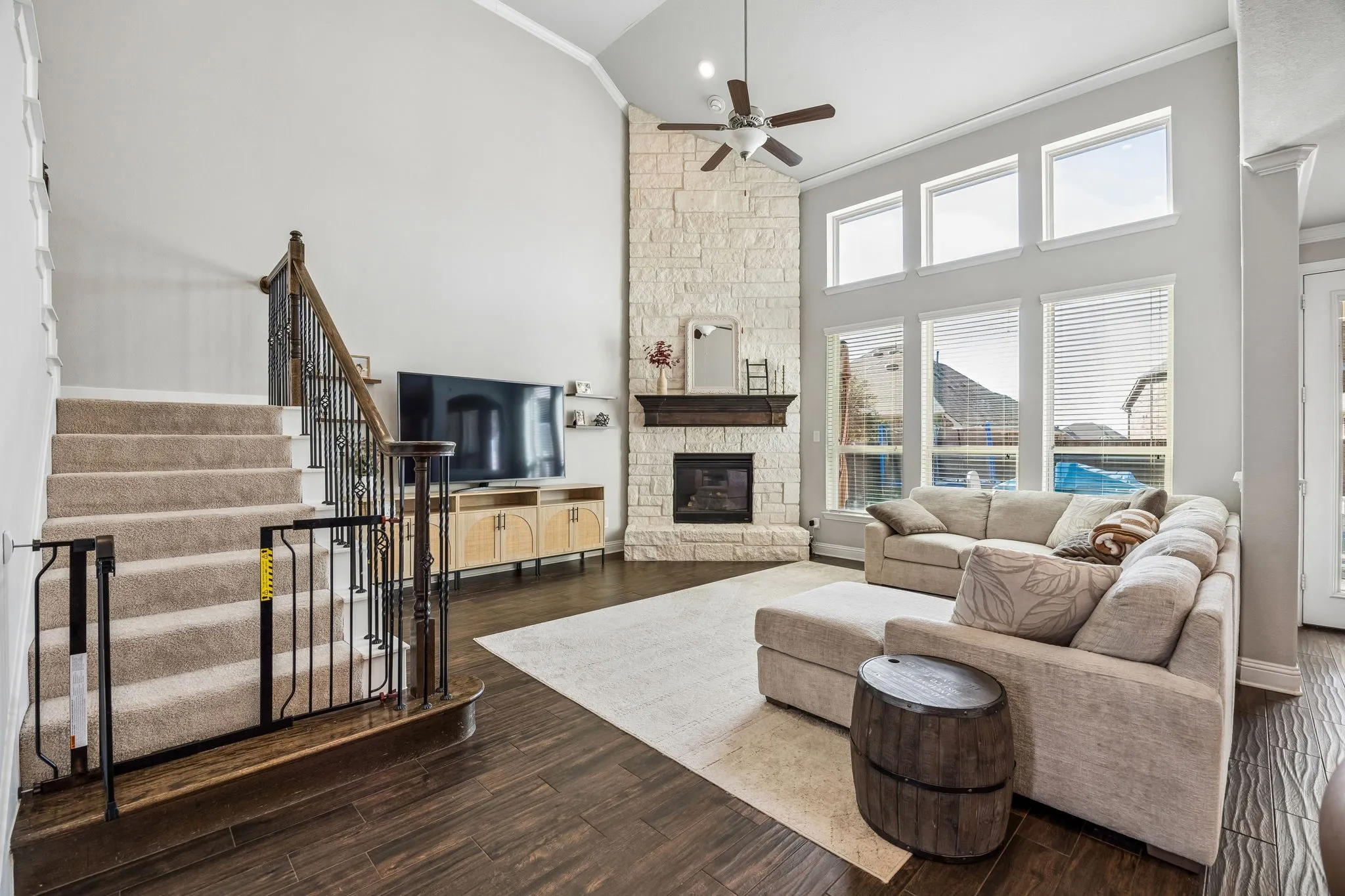 Family room open to the kitchen with floor to ceiling stone fireplace.