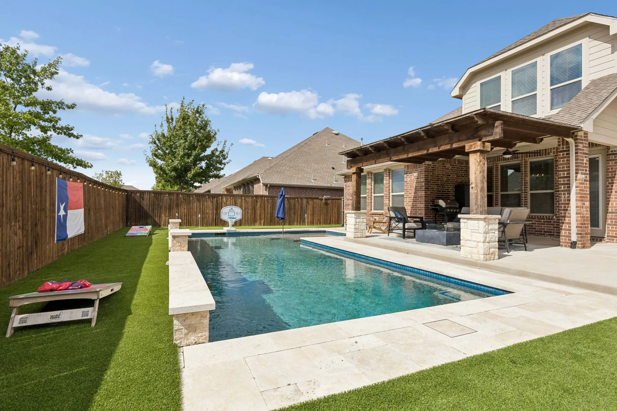 This backyard has it all. Pool with heater, per friendly turf and a 3 hole putting green!