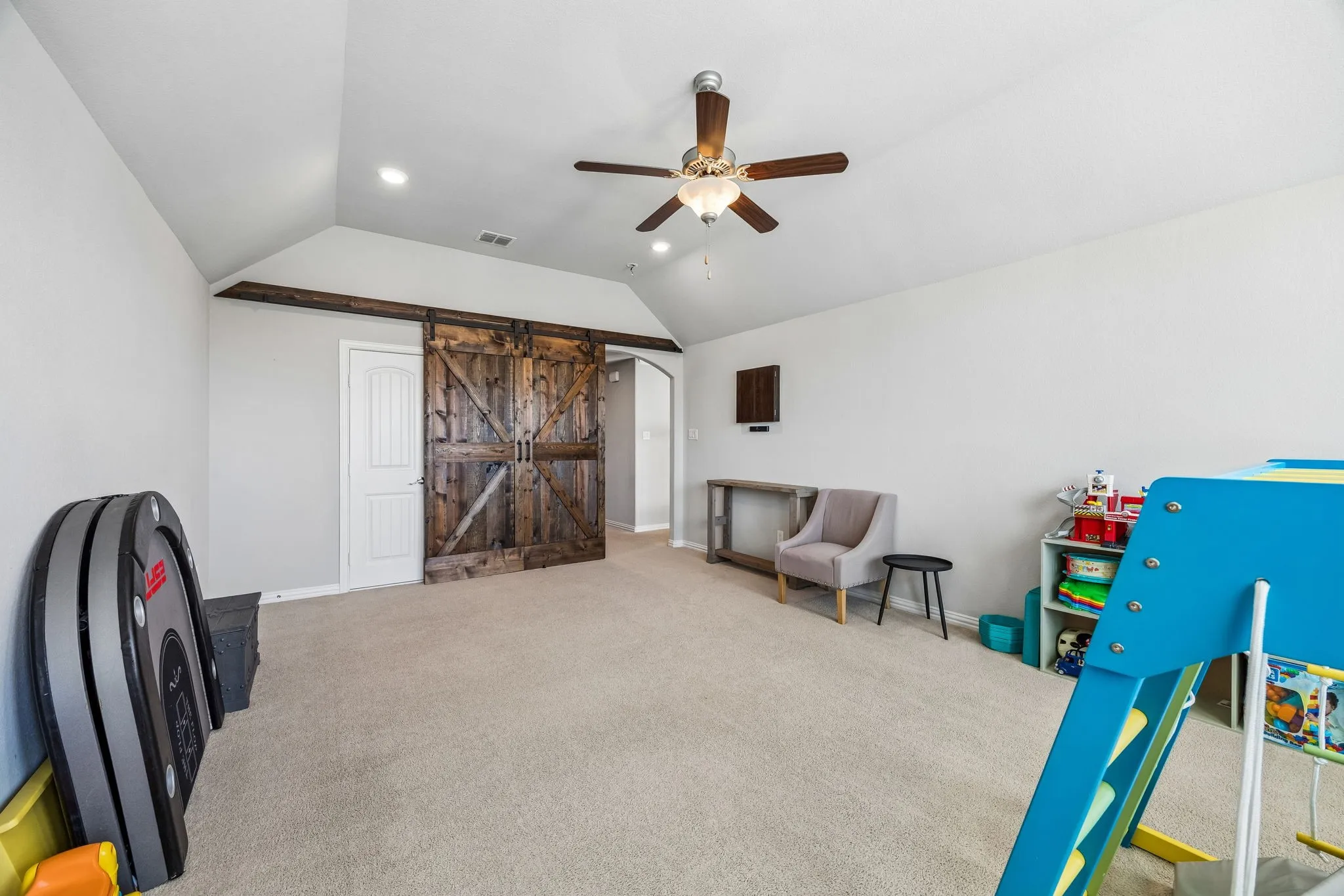 Large gameroom upstairs with a custom barn door